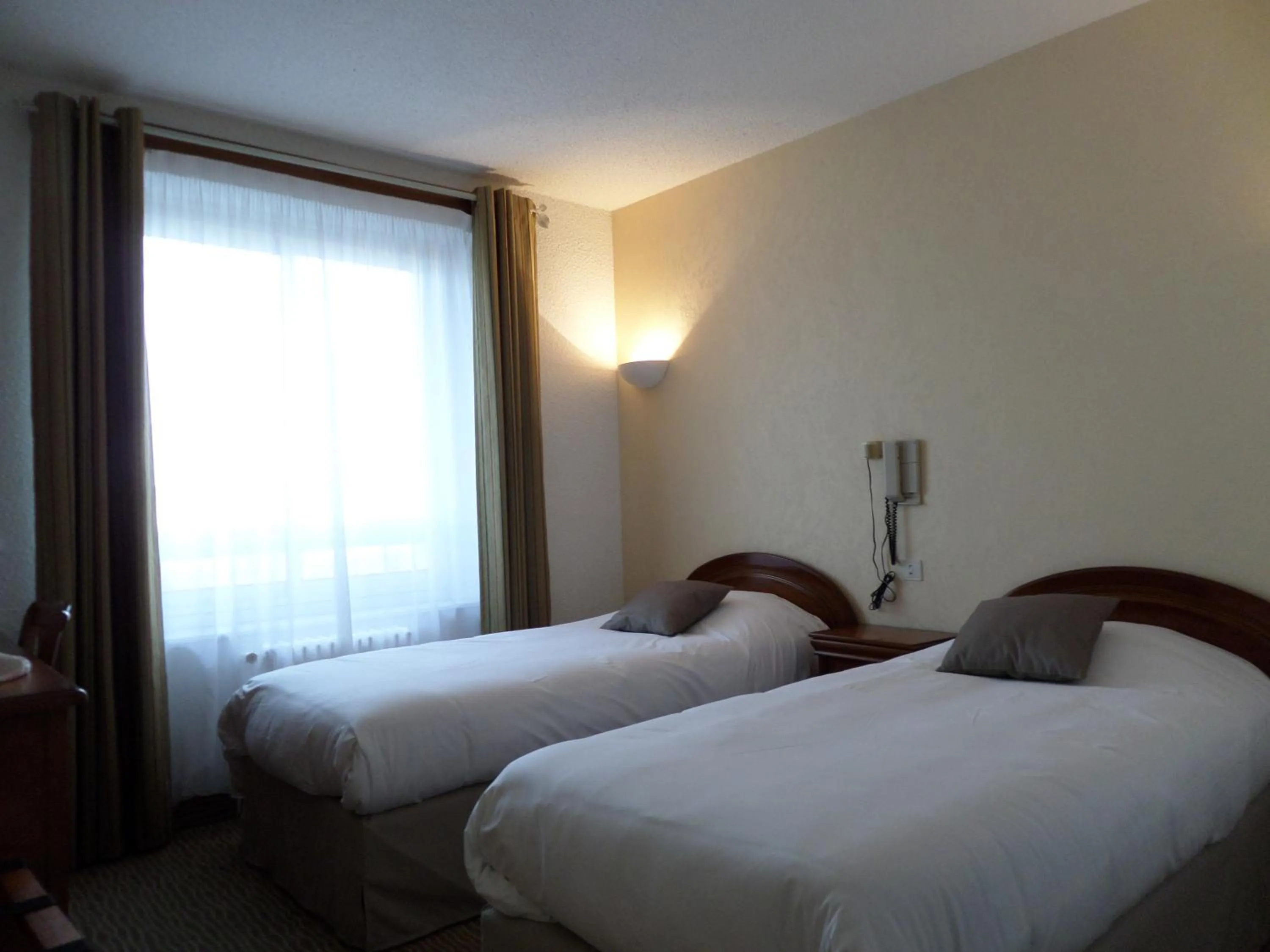 Bed in Hotel Des Tilleuls