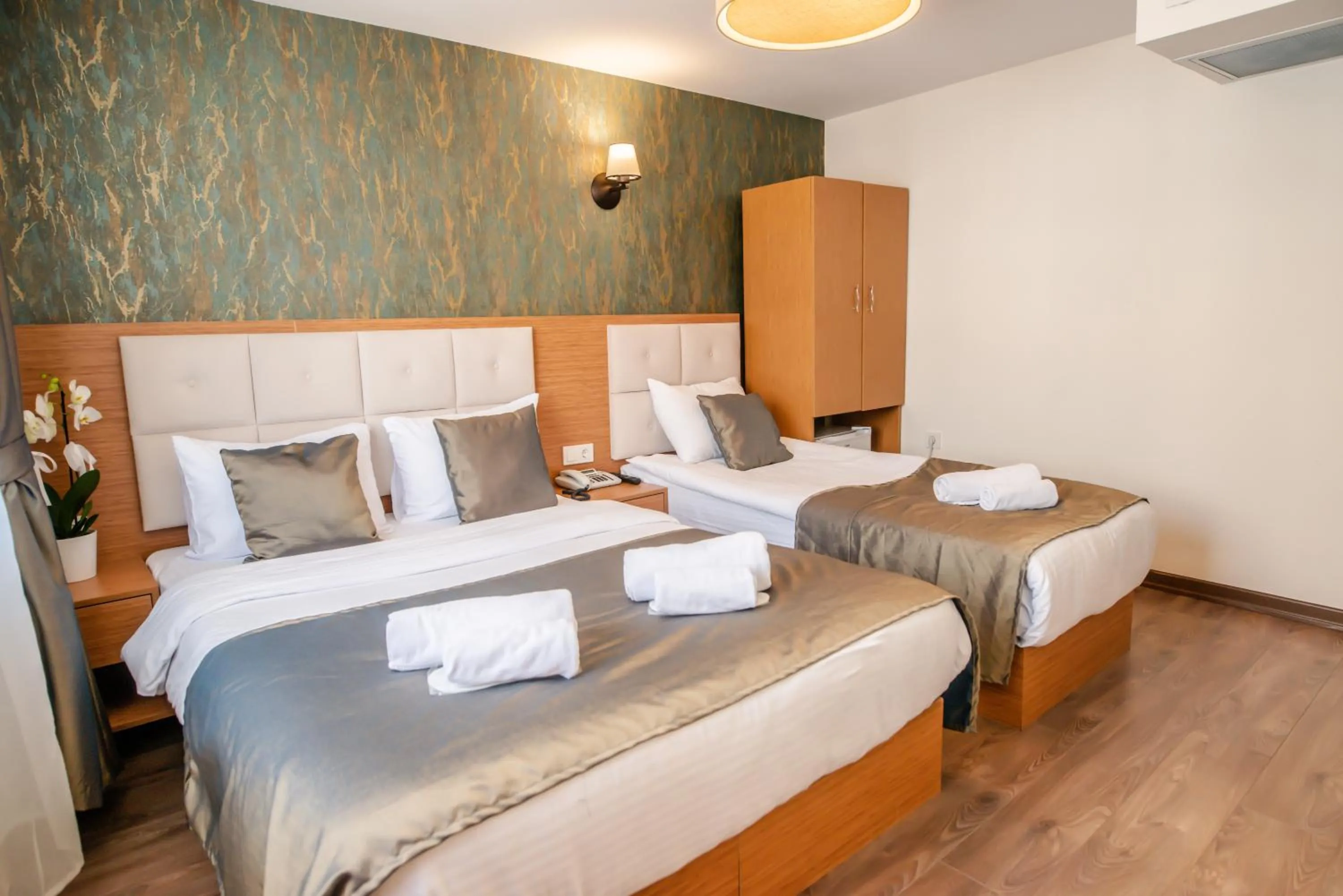 Bed in The Camelot Hotel