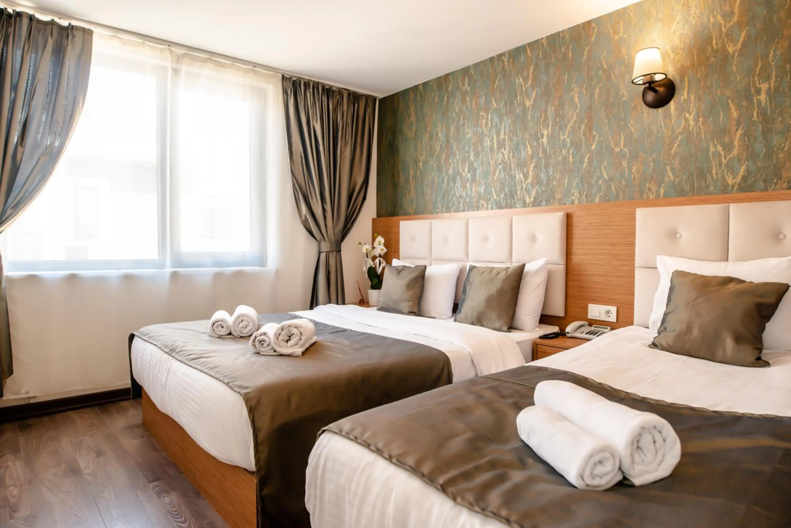 Bed in The Camelot Hotel