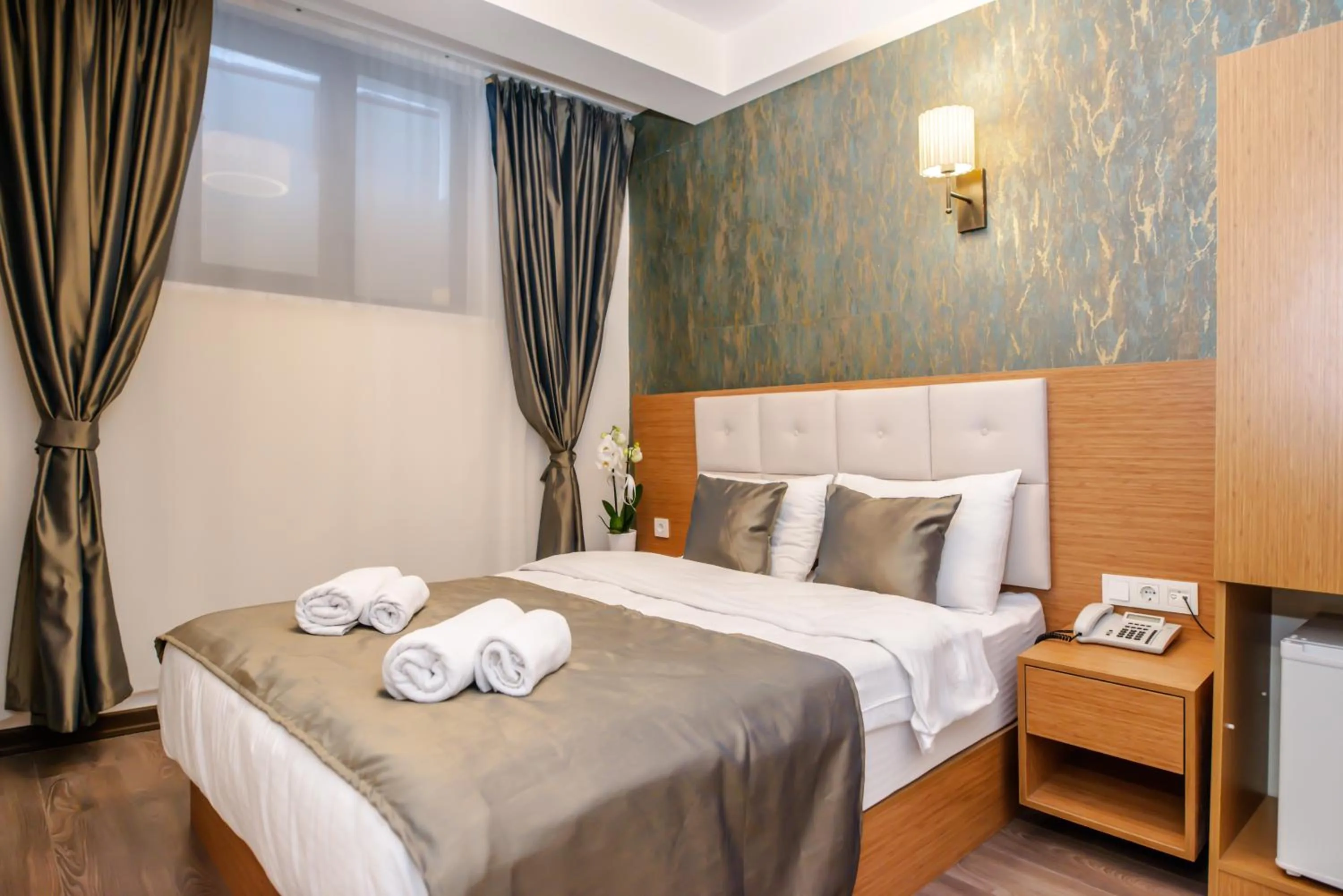 Bed in The Camelot Hotel