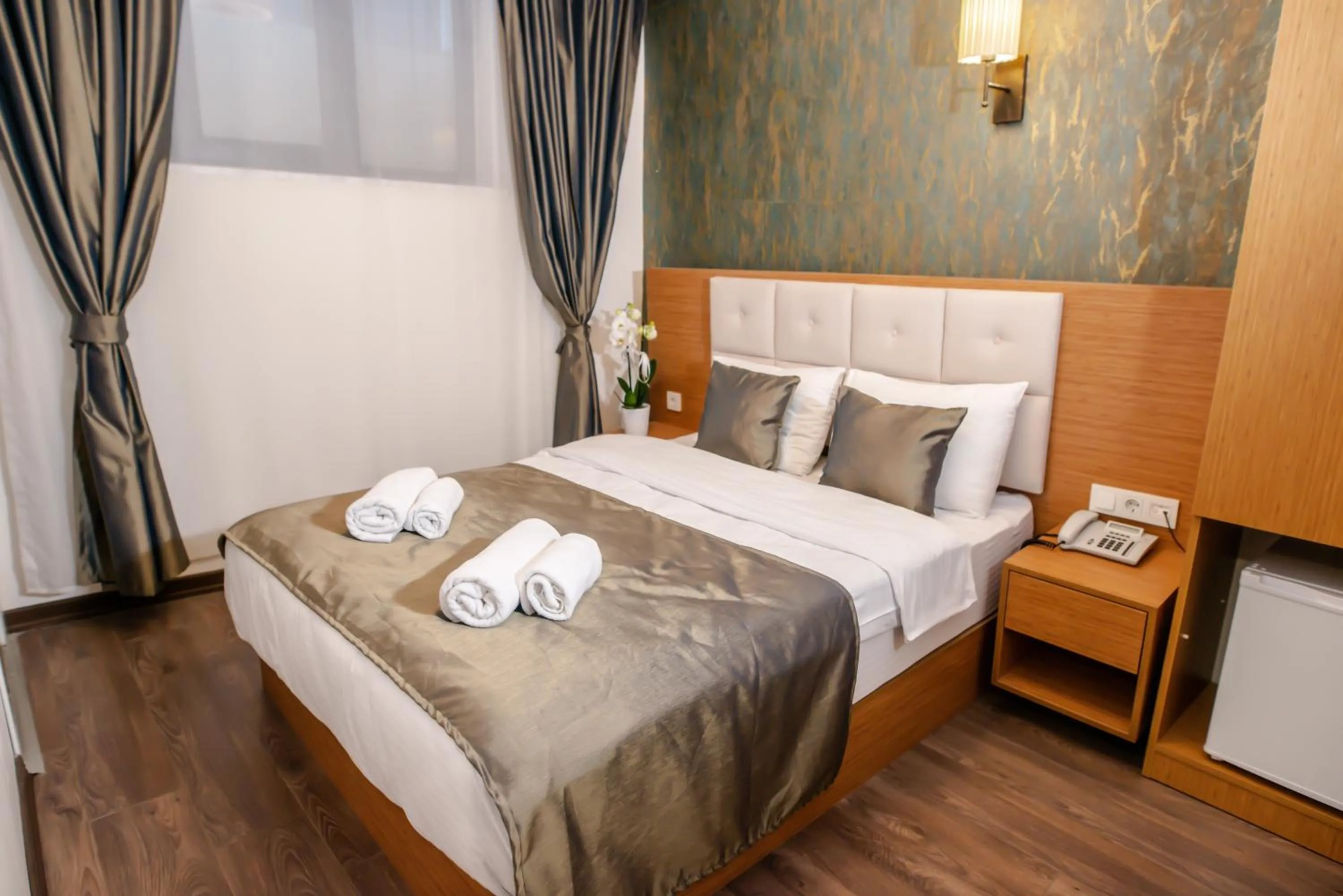 Bed in The Camelot Hotel