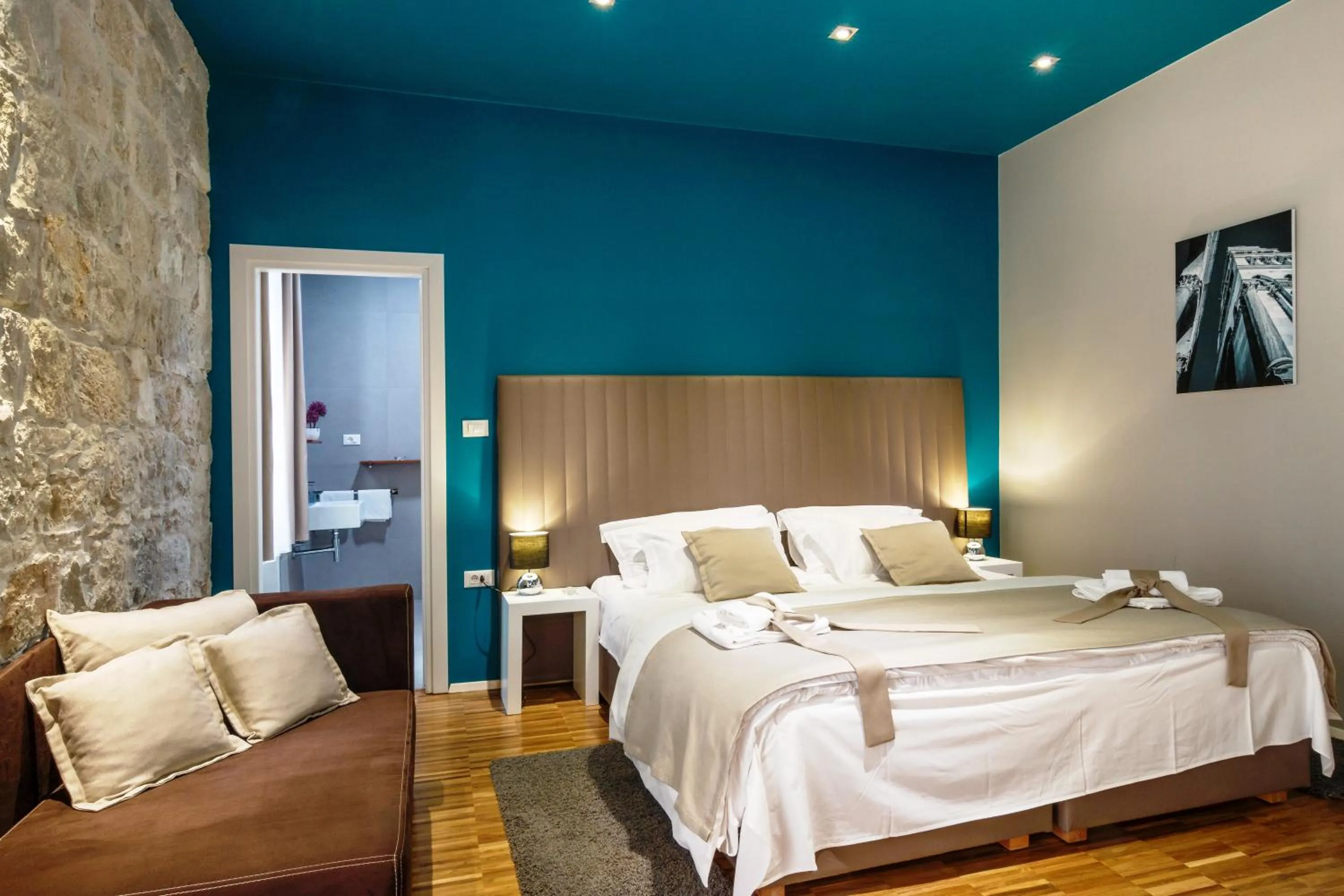 Bed in Riva Luxury Rooms