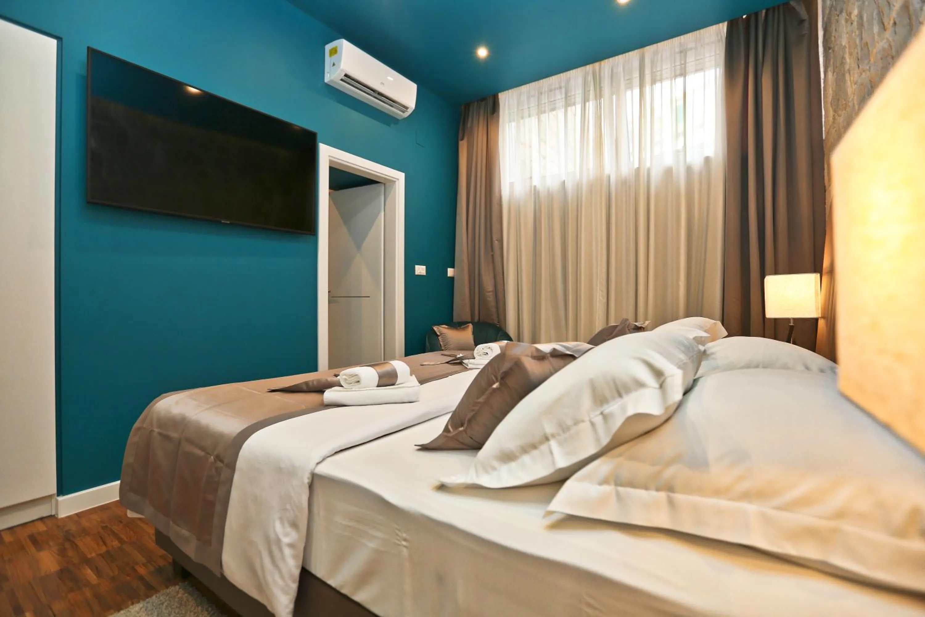 Bed in Riva Luxury Rooms