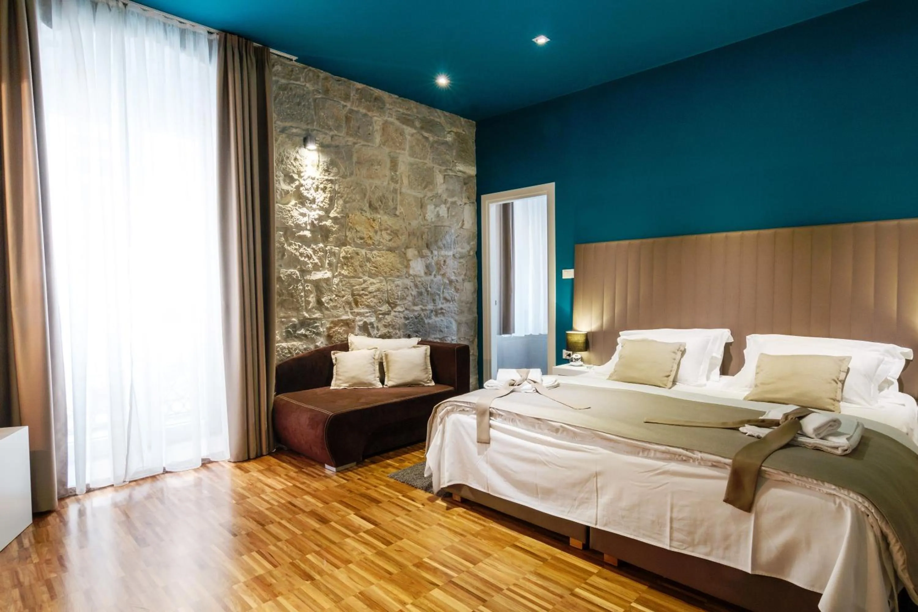 Bed in Riva Luxury Rooms