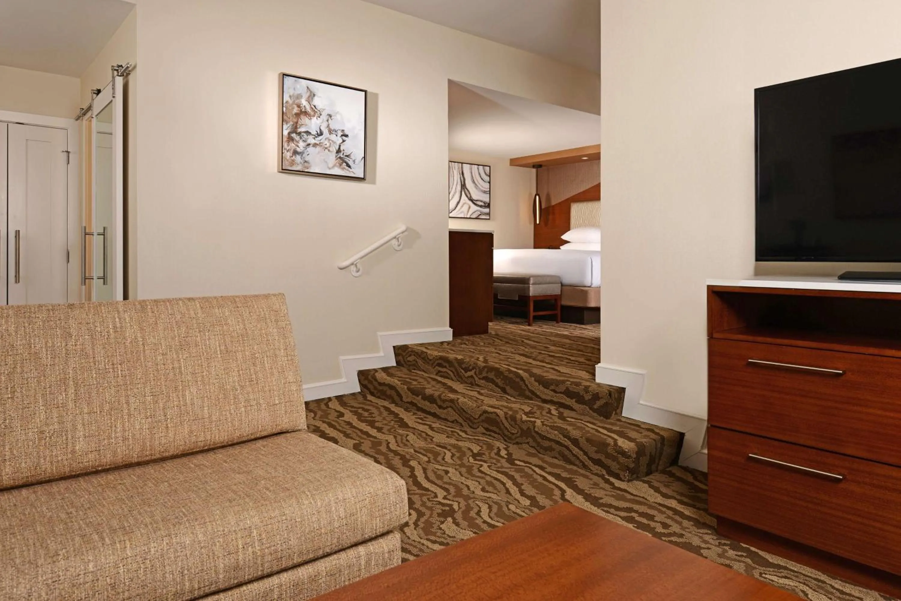 Living room, Bed in The Inverness Denver, a Hilton Golf & Spa Resort