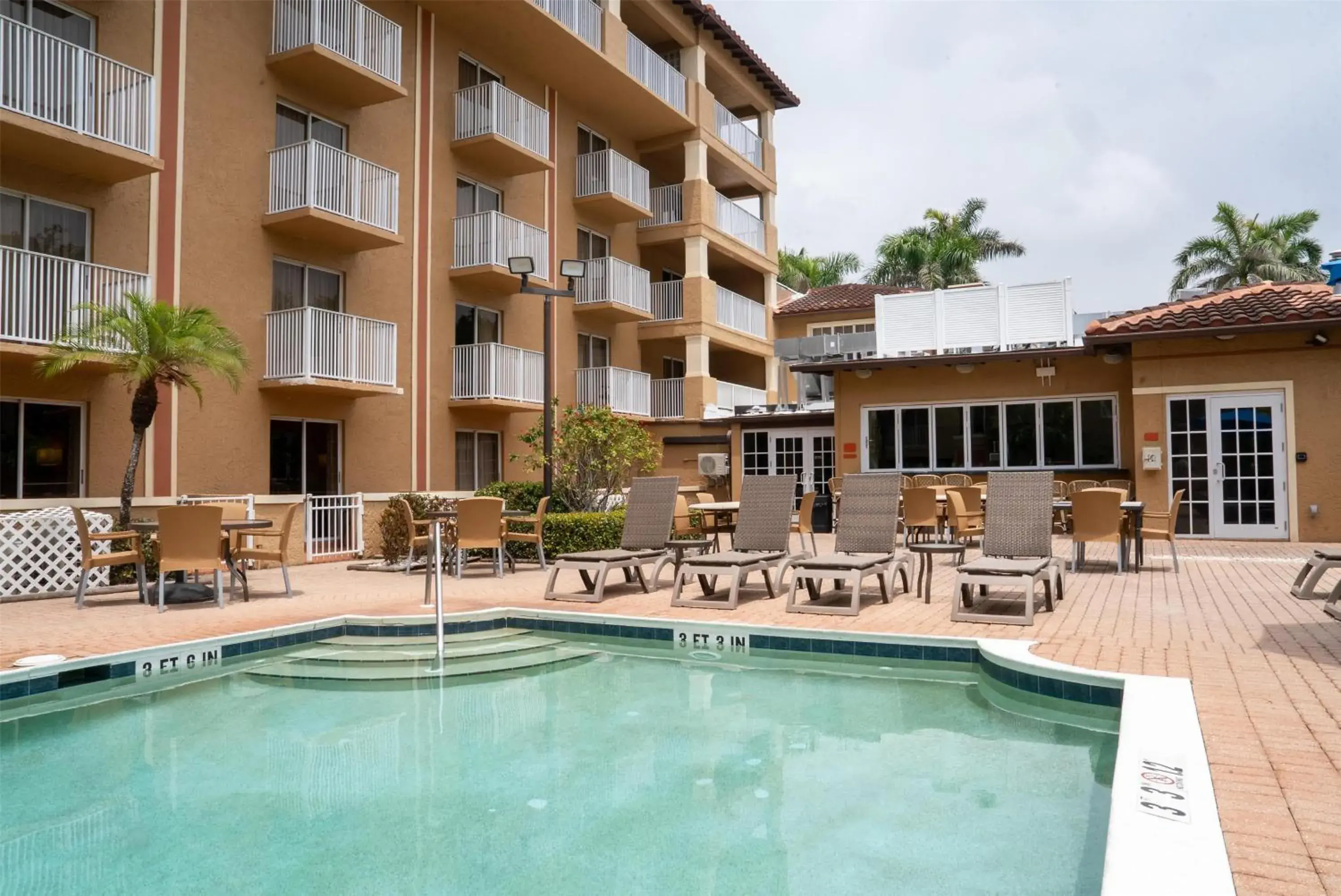 Pool view in Inn of Naples, Tapestry Collection by Hilton Pool view in Inn of Naples, Tapestry Collection by Hilton