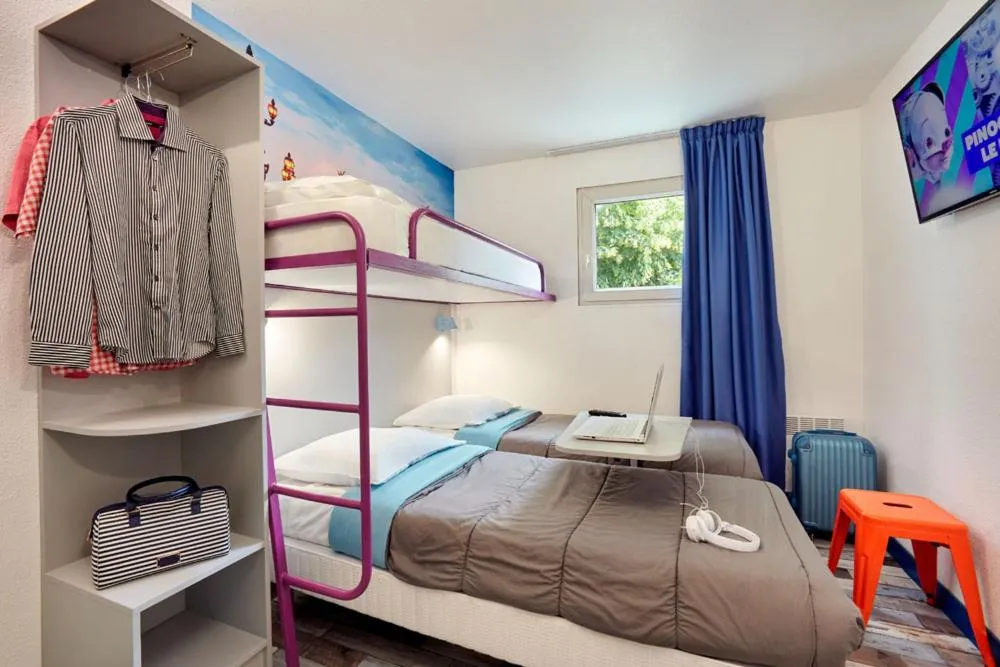 Bed in Welcomotel Les Mureaux