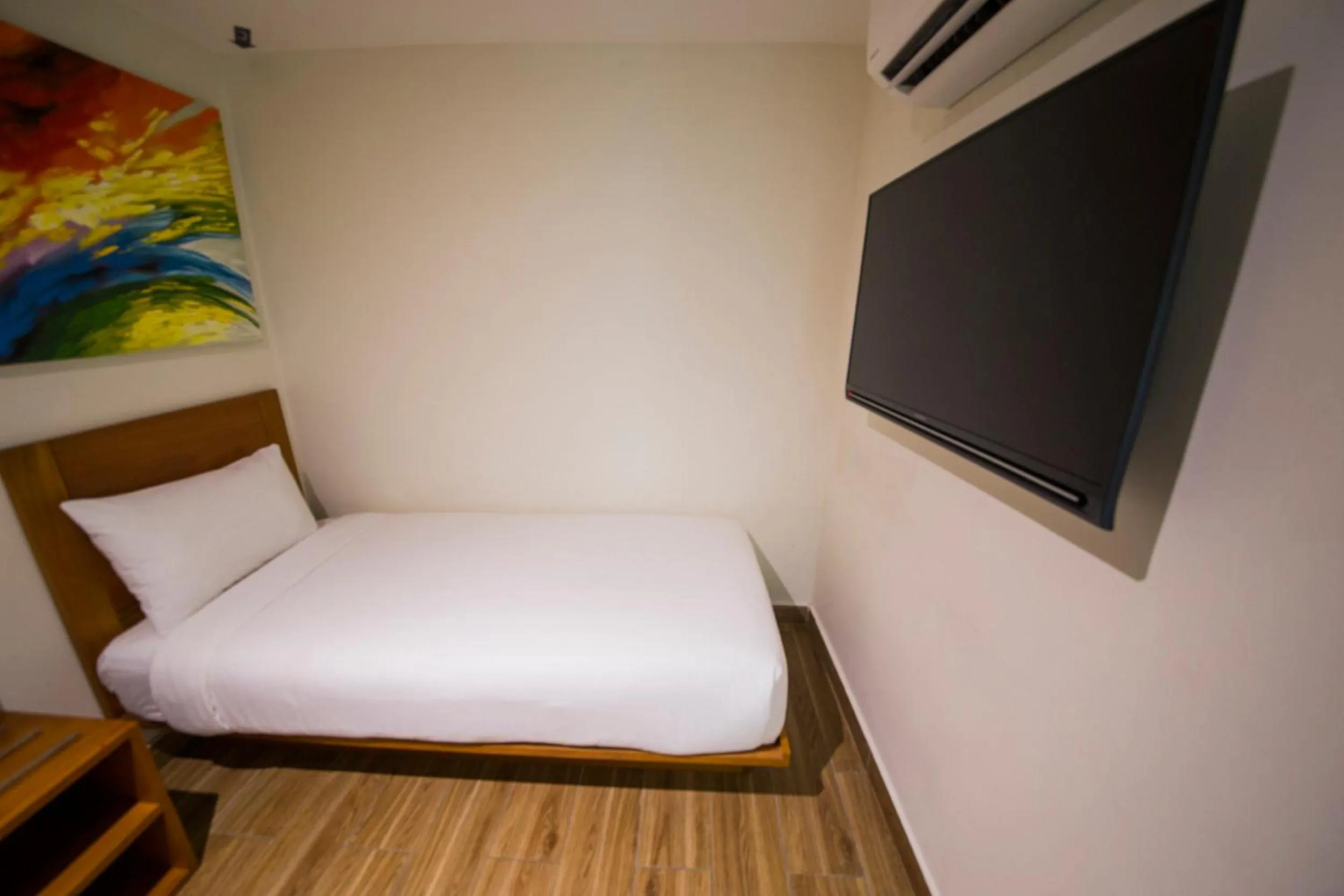 Bed in The Point Boutique Hotel