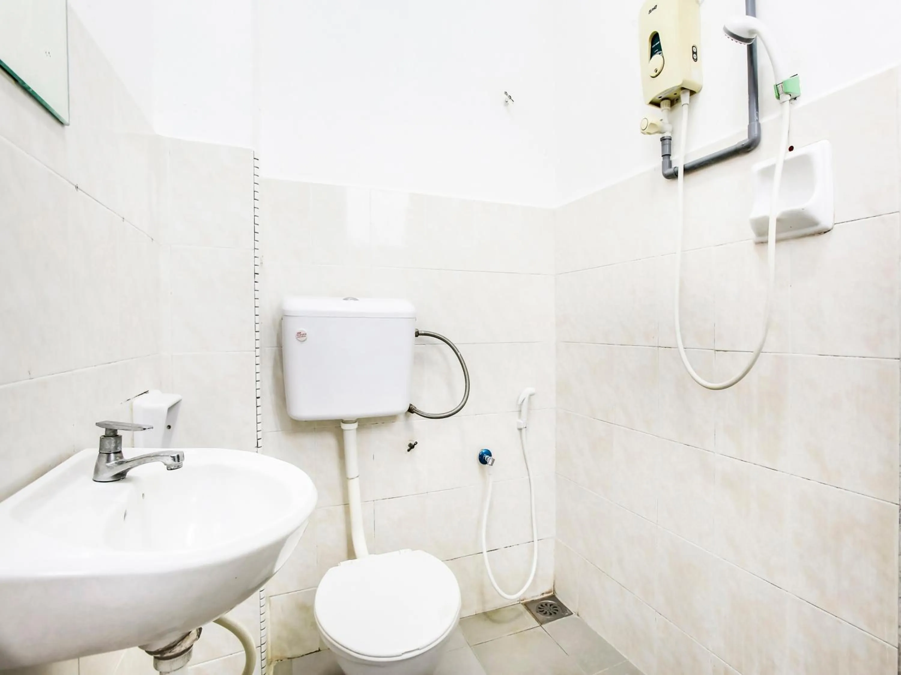 Bathroom in OYO 89615 T Family Hotel