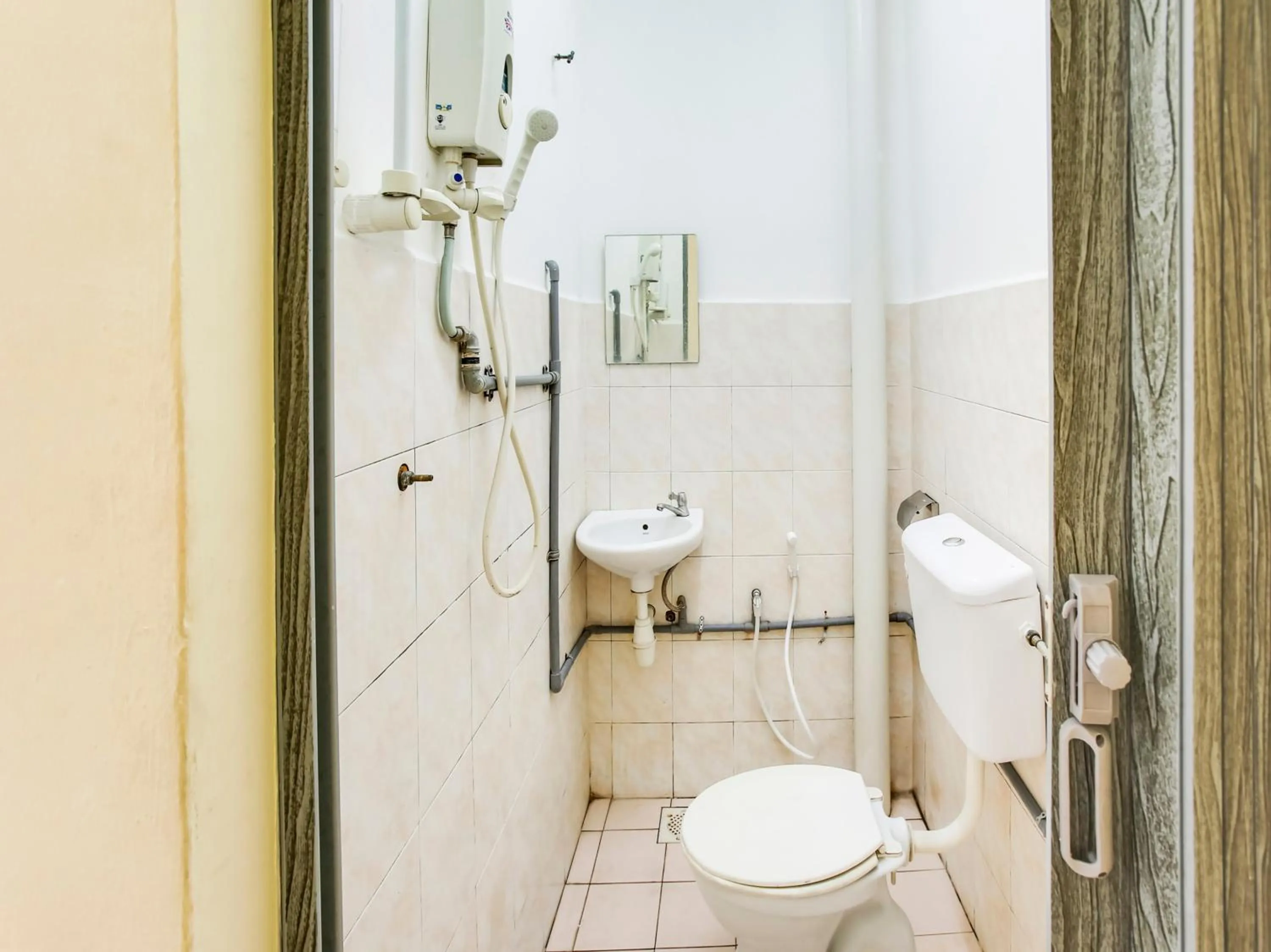 Bathroom in OYO 89615 T Family Hotel