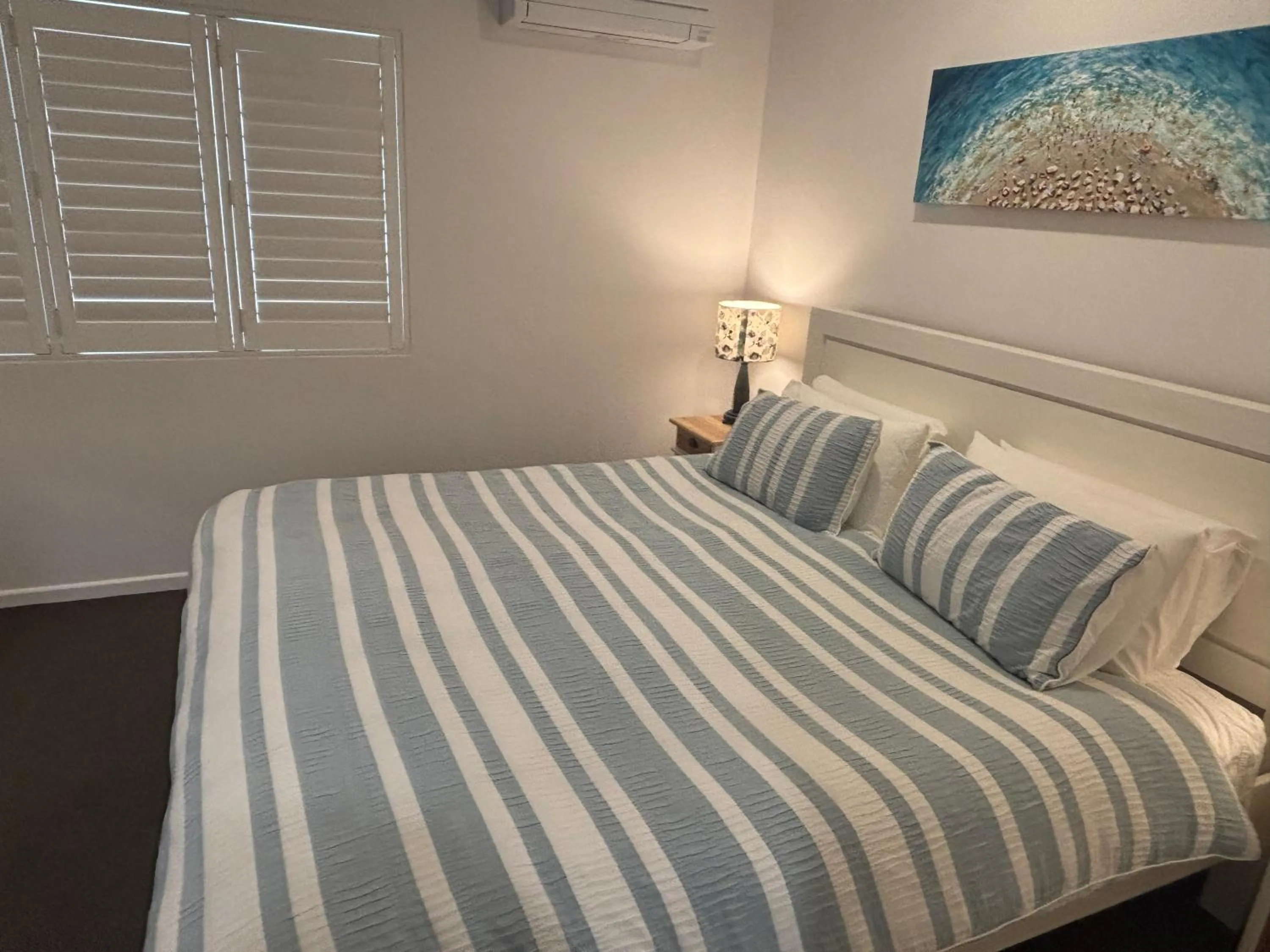 Bed in Aqua Promenade Beachfront Holiday Apartments