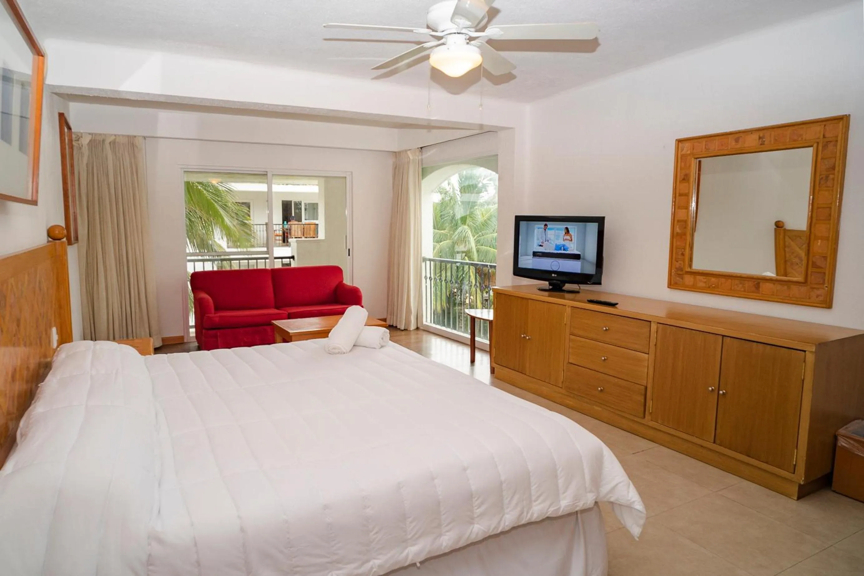 Photo of the whole room, Bed in Oceanfront condo at voted best Cancun sandy beach
