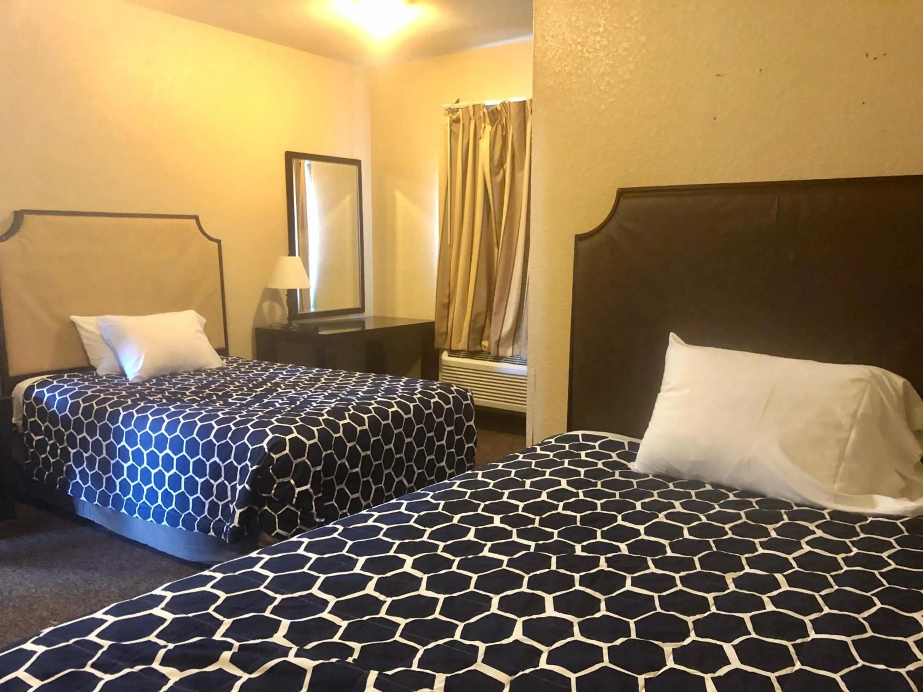 Bed in Lone Star Inn & Suites