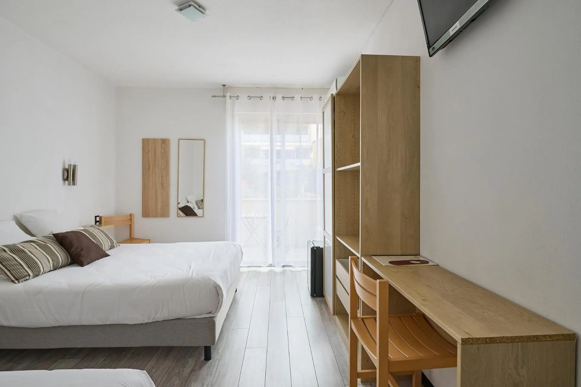 Bedroom in Hôtel Les Mimosas