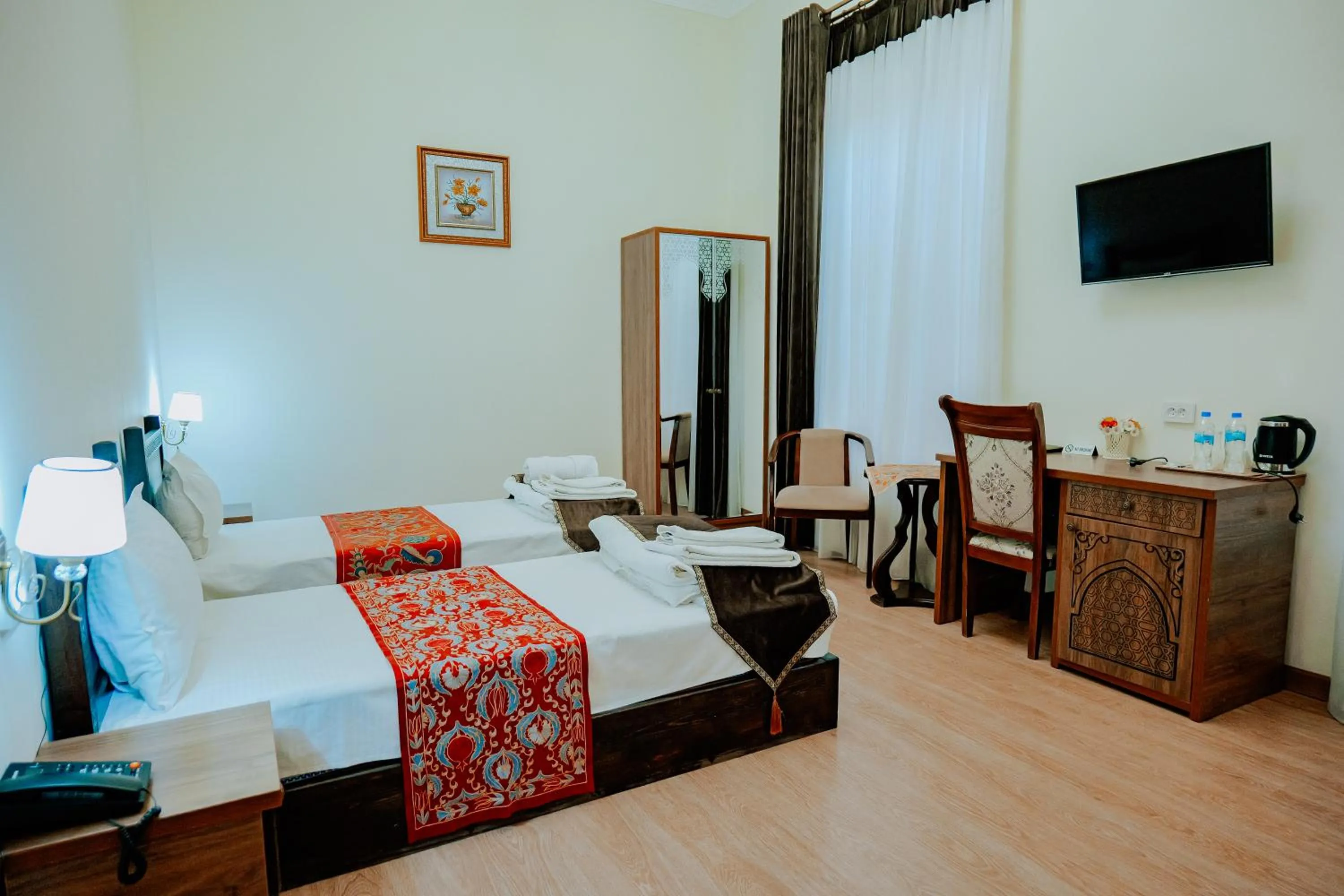 Communal lounge/ TV room in Imperial Palace Bukhara