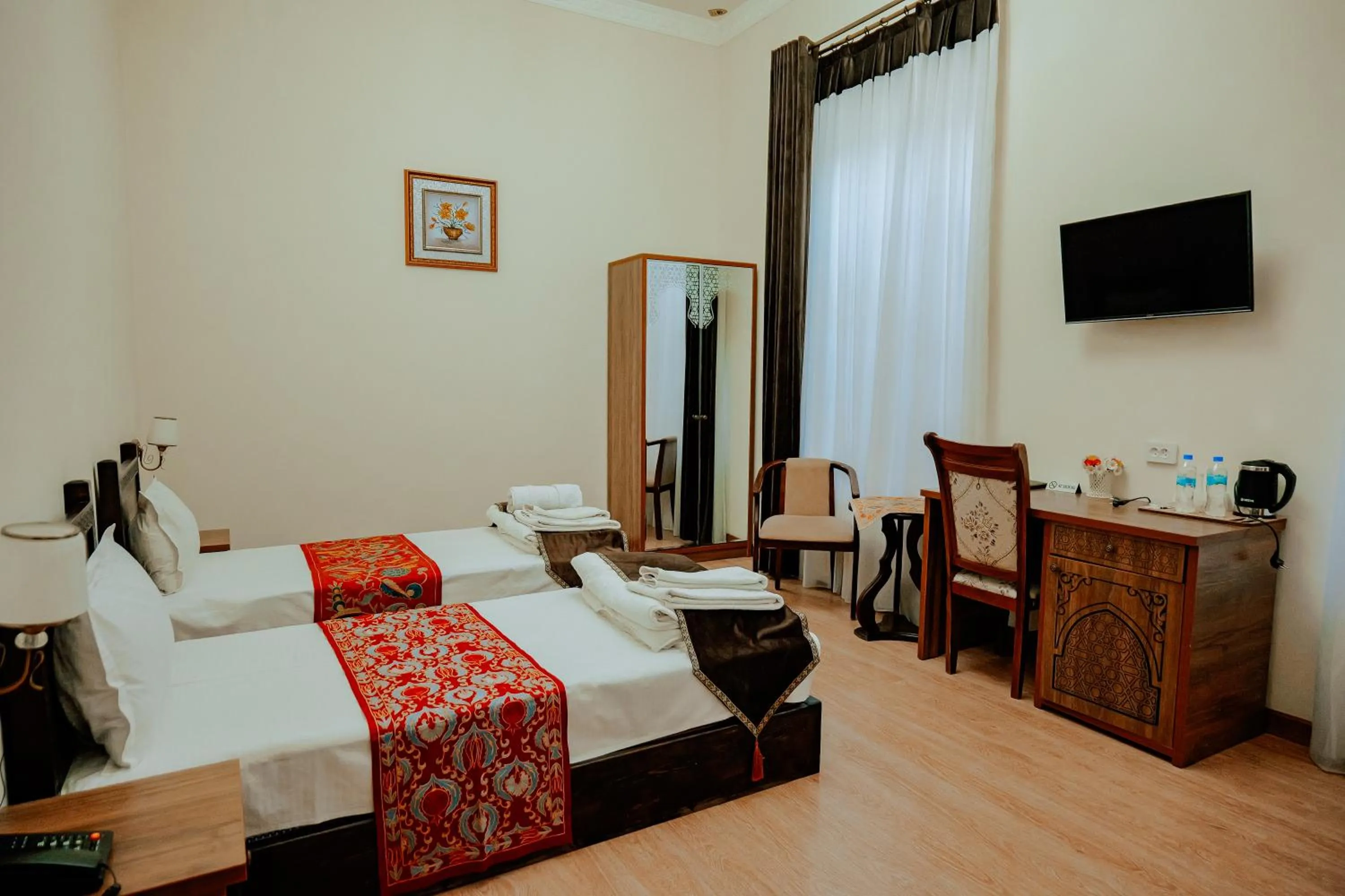 Communal lounge/ TV room in Imperial Palace Bukhara