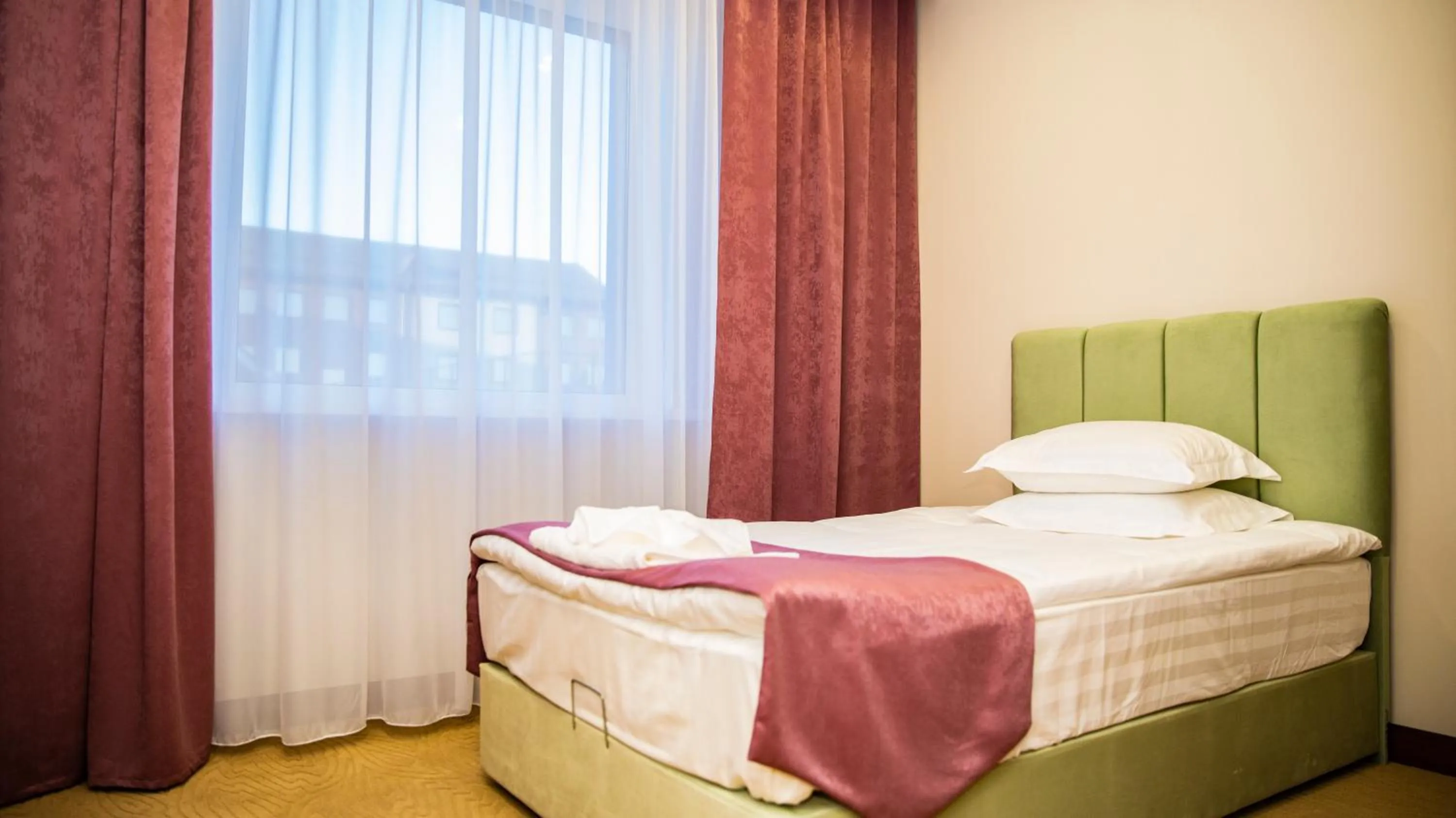 Bed in SULO Atyrau Hotel