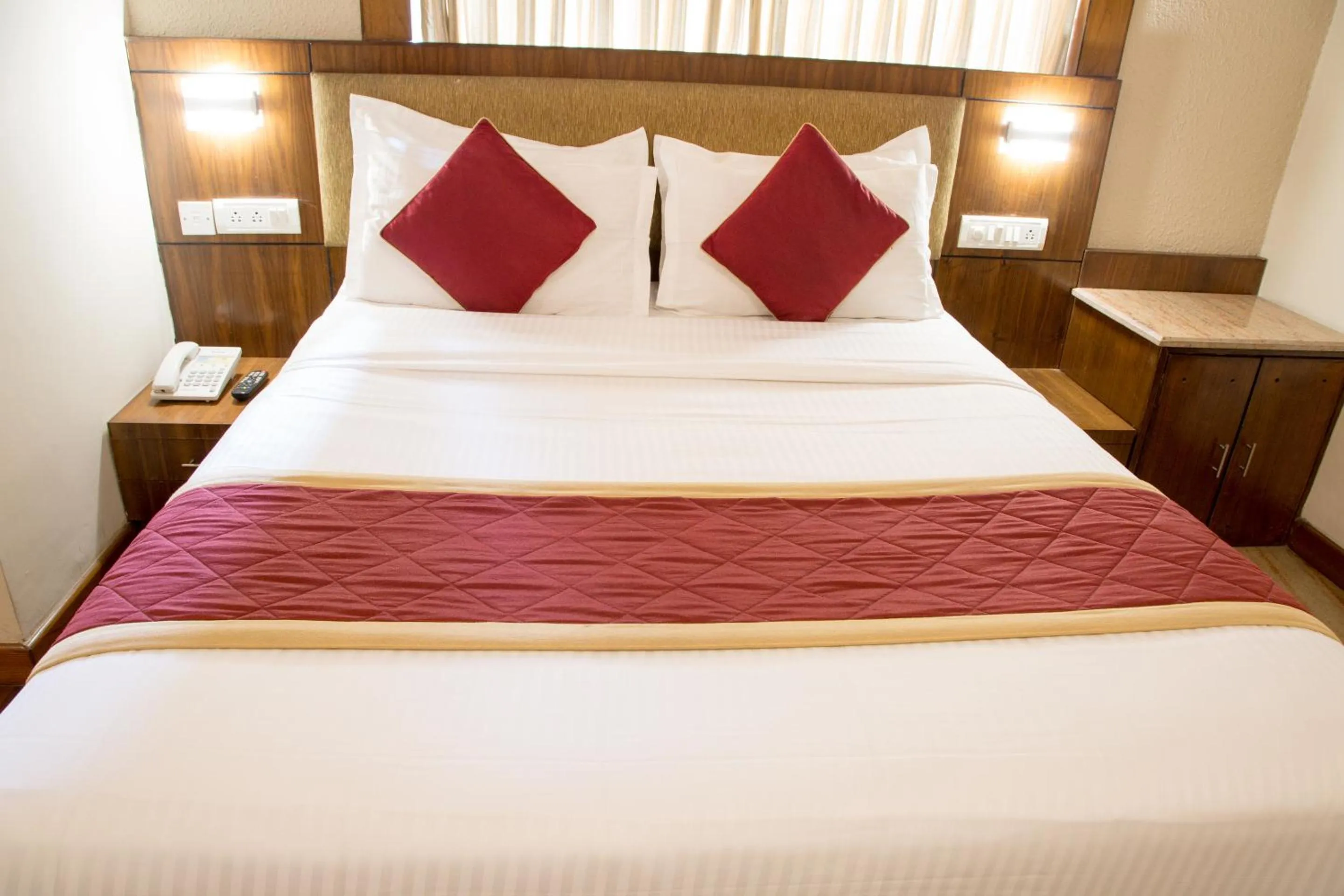 Bed in New Rainbow Business Hotel