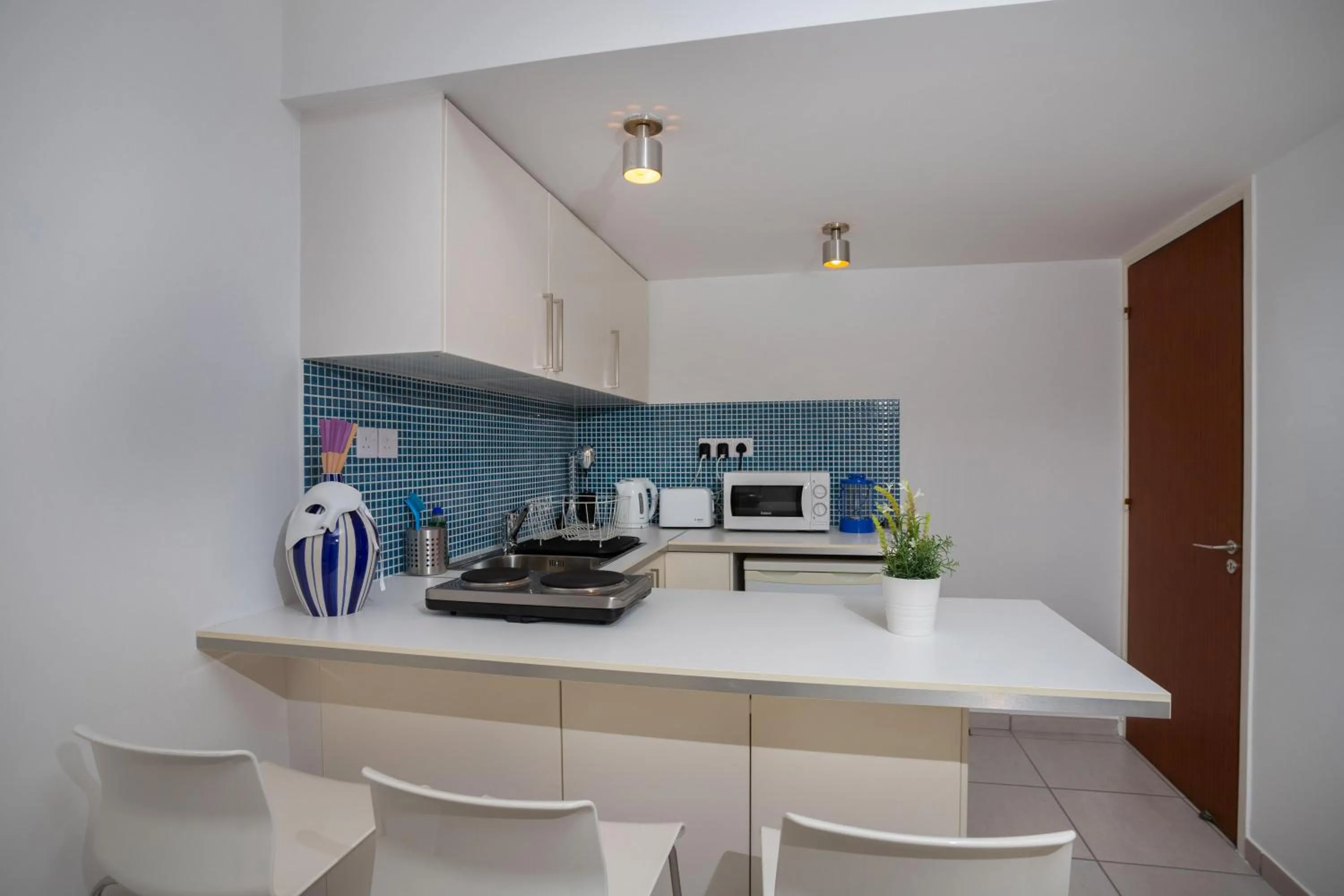 Kitchen or kitchenette in Athenaeum Beachside Apt by TrulyCyprus