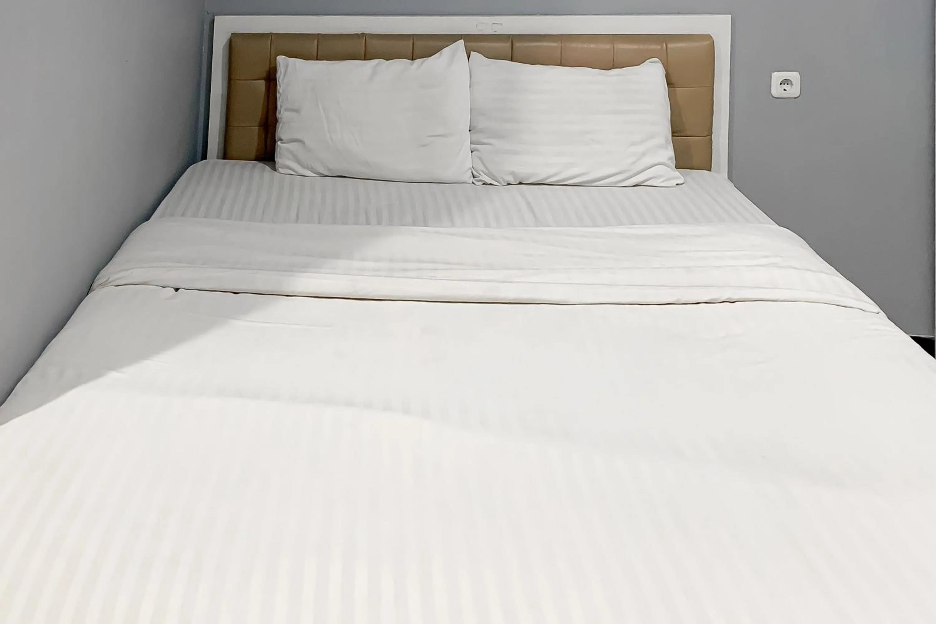 Bed in Karins Guesthouse Syariah RedPartner