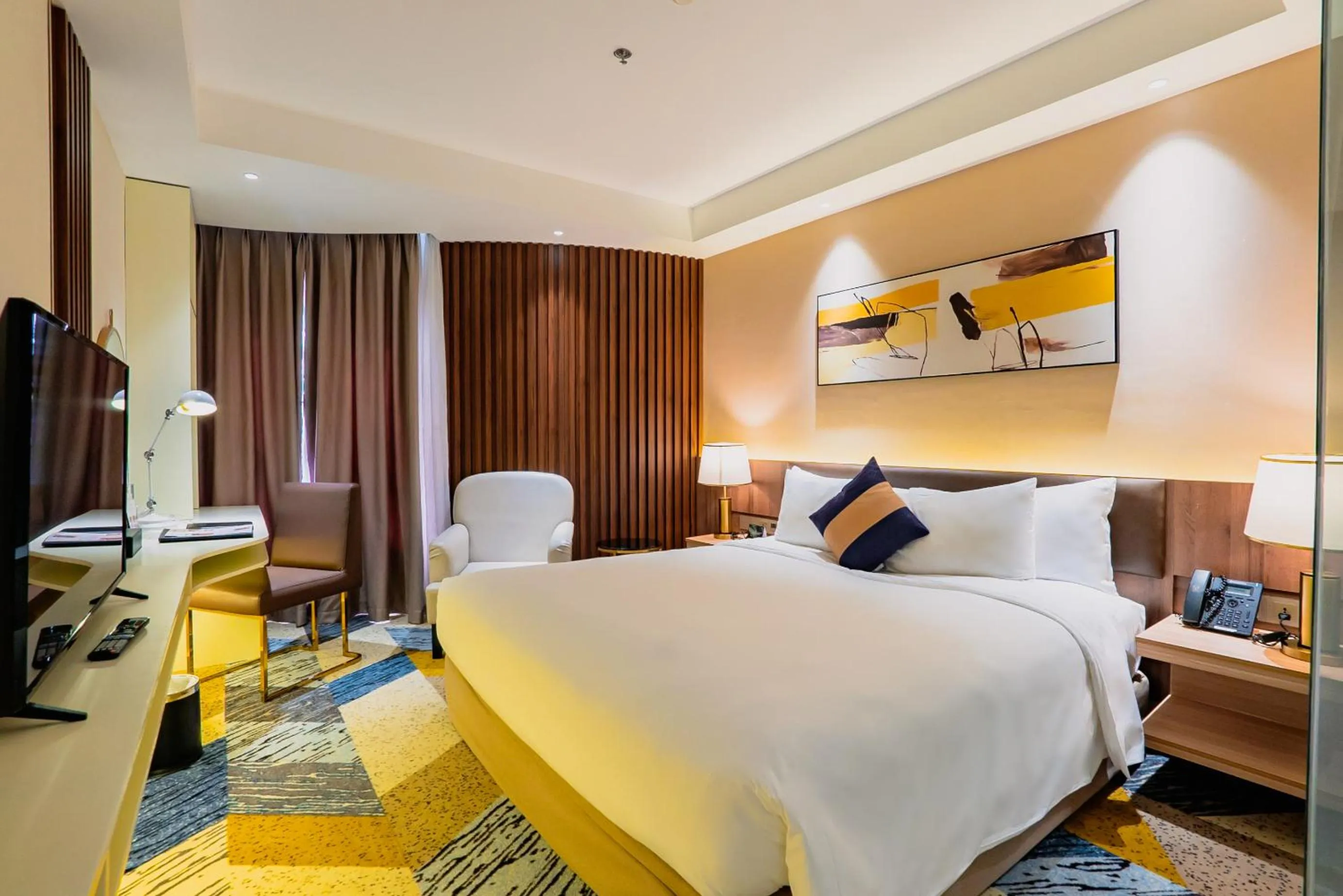 Bed in La Vela Saigon Hotel