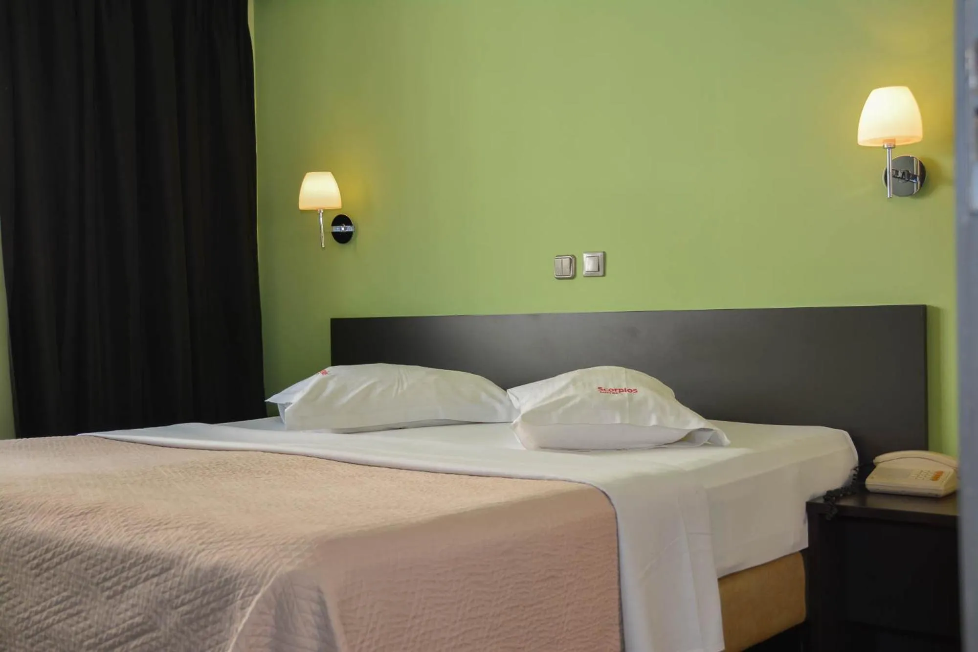 Bed in Scorpios Sea Side Hotel