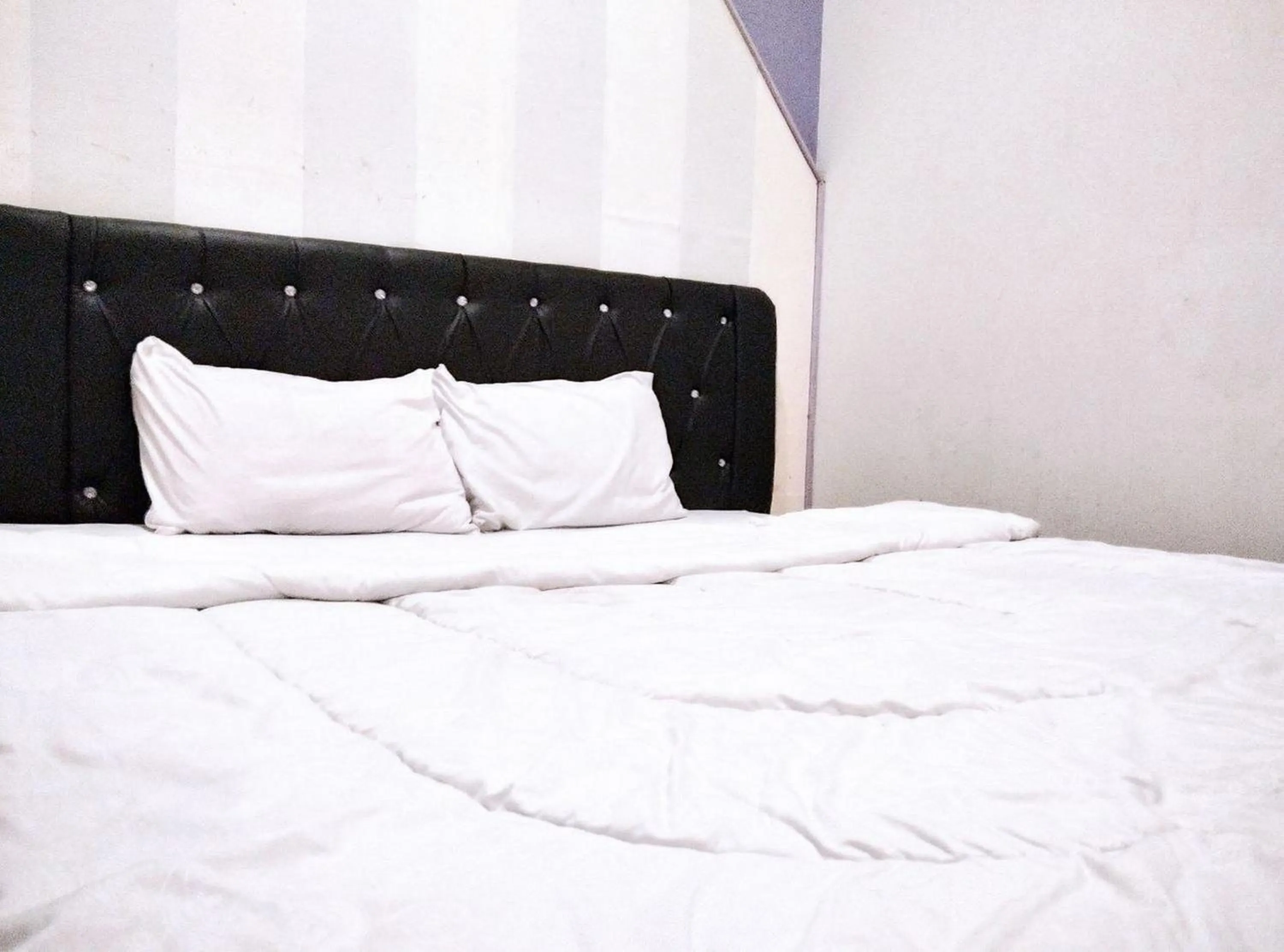 Bed in Gangnam Style Residence Mitra RedDoorz near MERR Surabaya