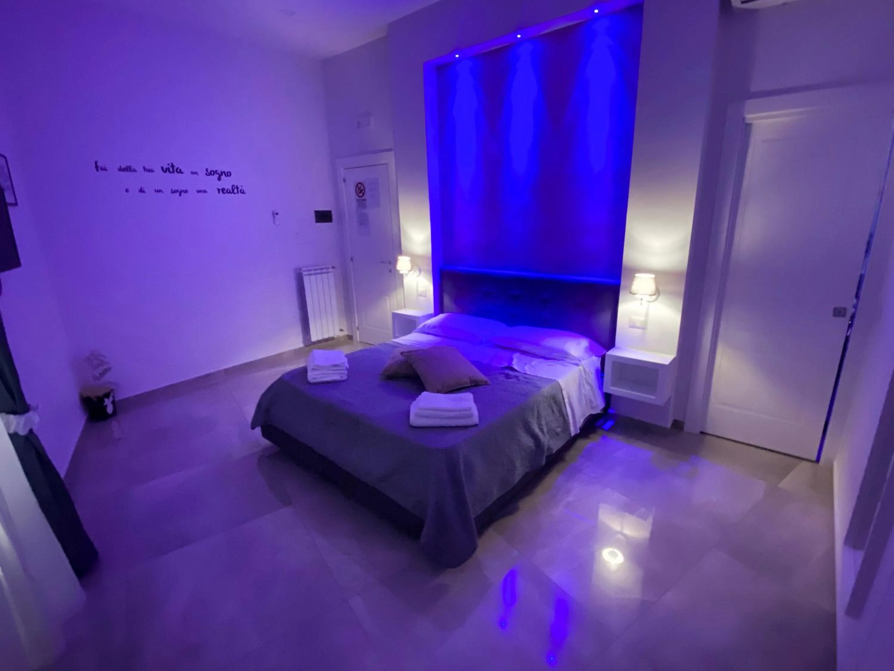 Bed in Aurora Luxury Rooms