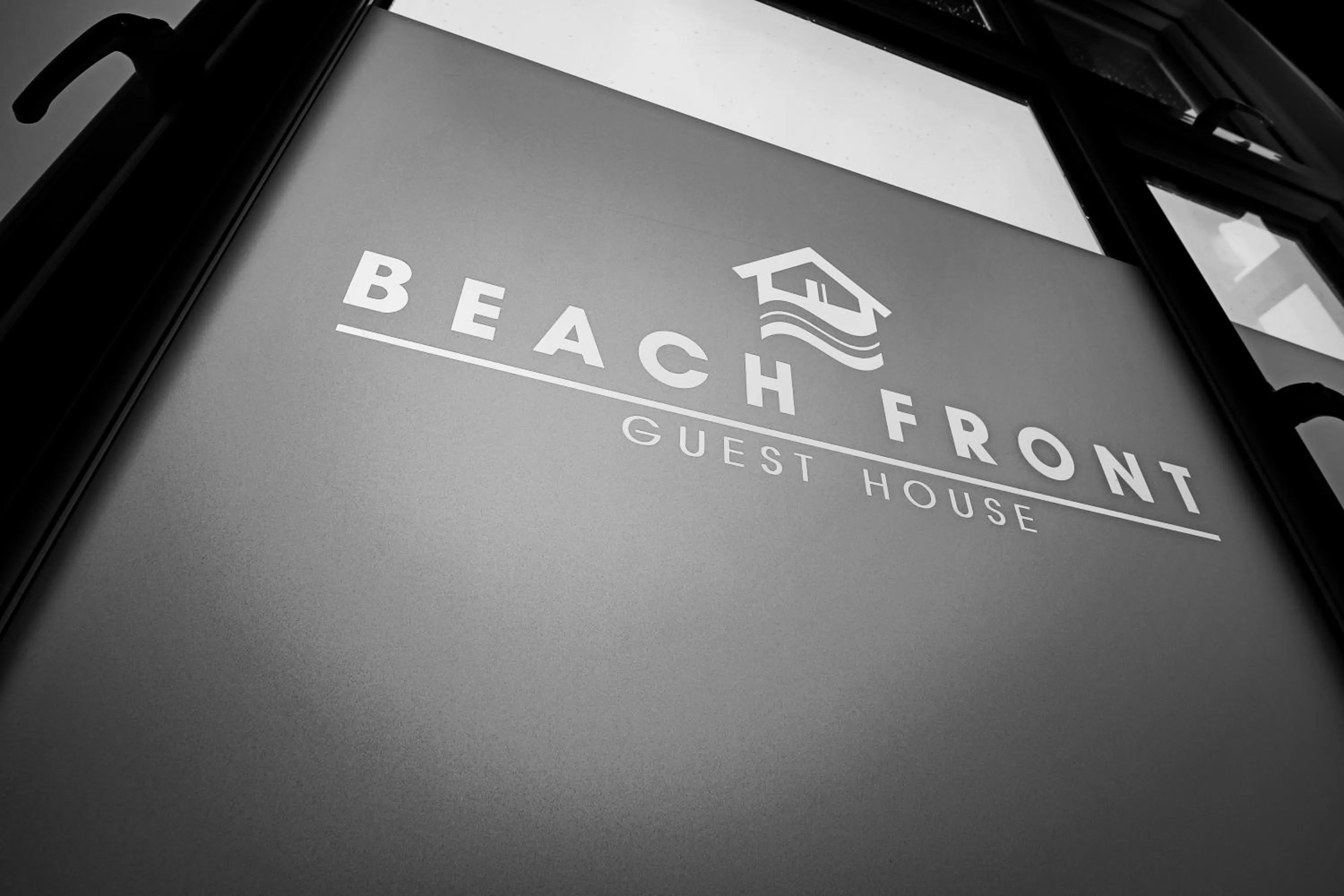 Property logo or sign in Beach Front Guest House