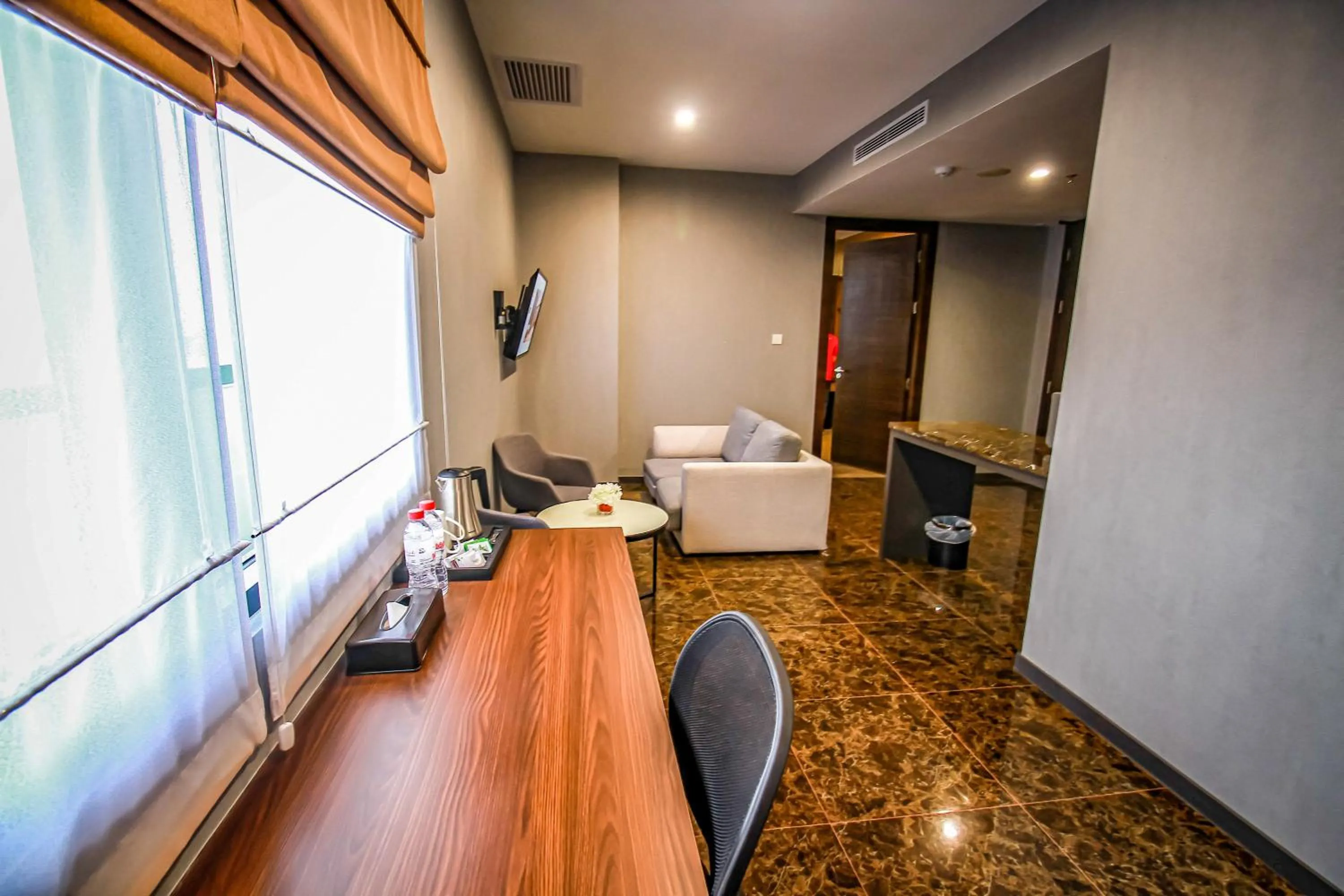 Living room in Asialink Hotel Batam by Prasanthi