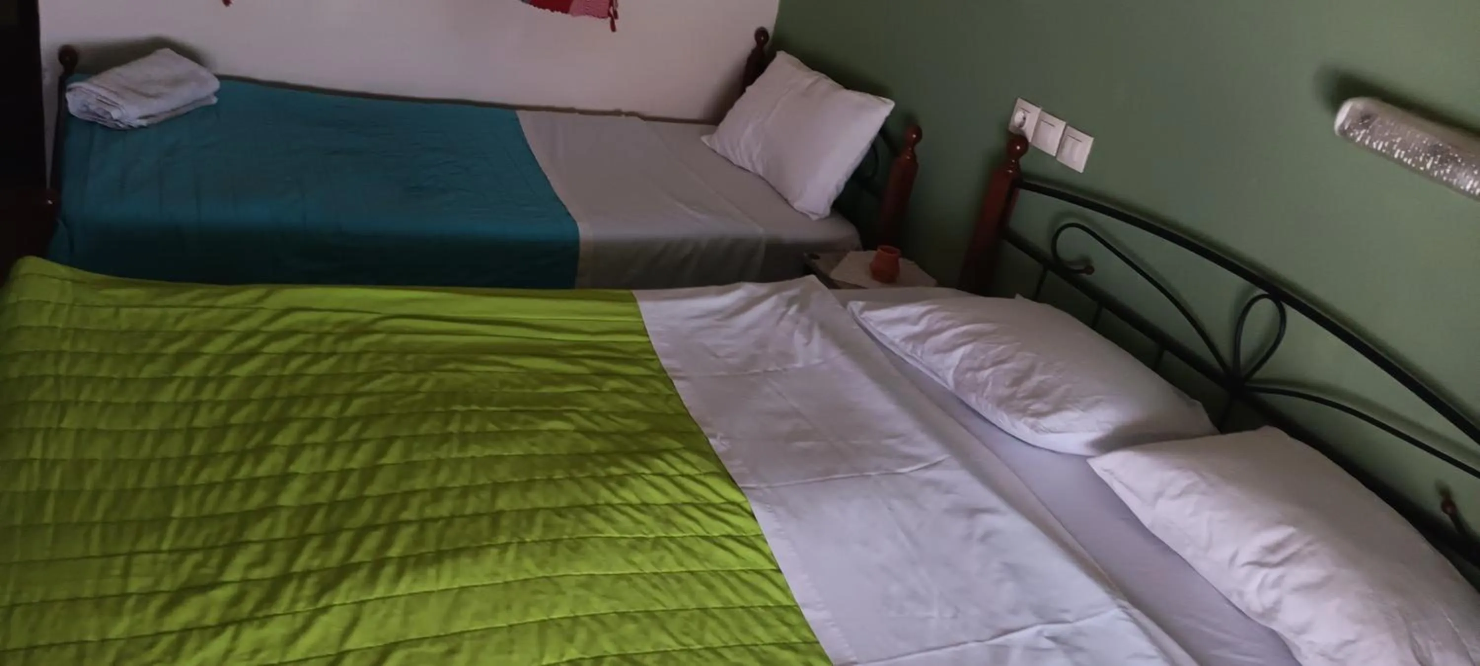 Bed in Hotel zakros rooms-restaurant
