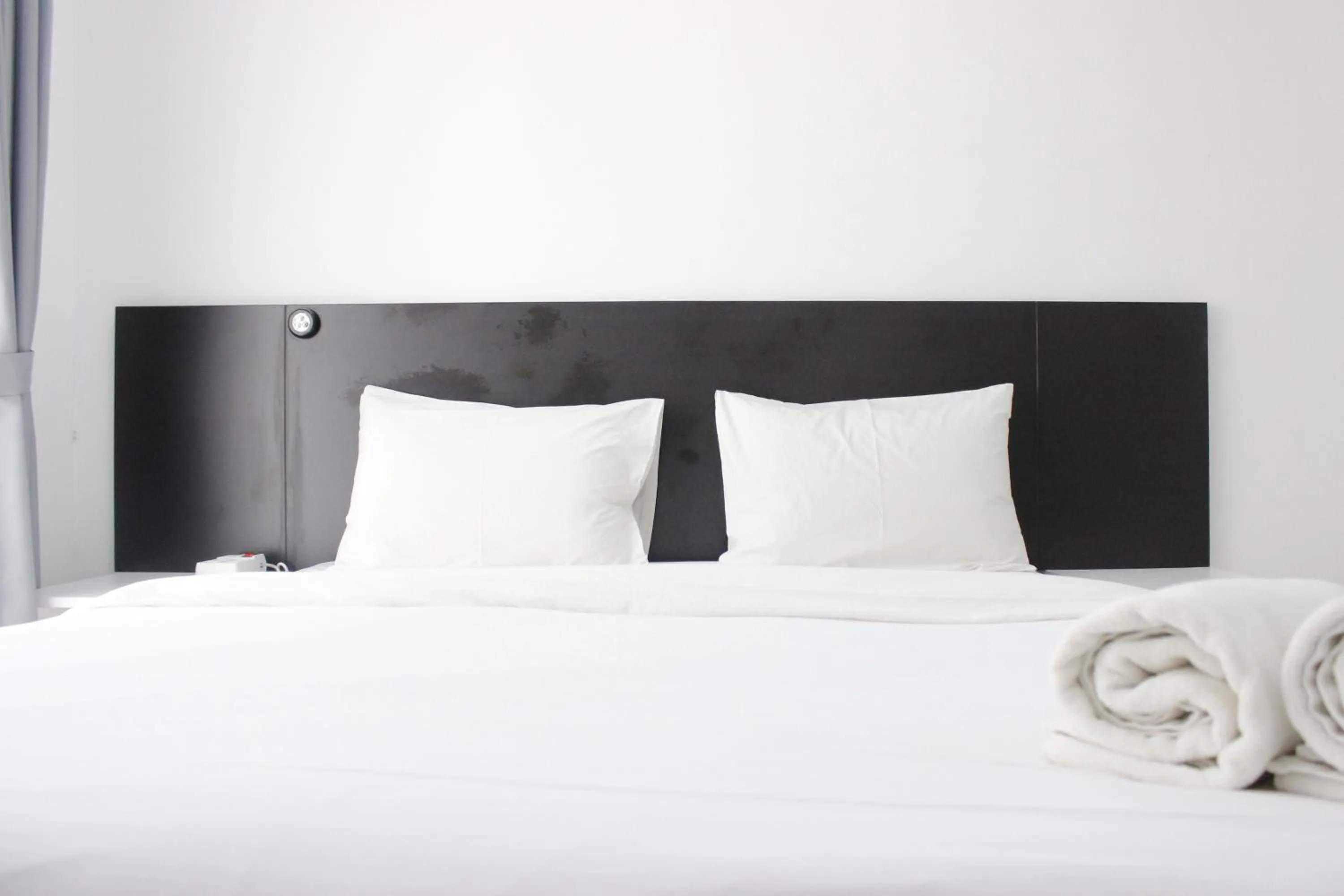 Bed in Monochrome Style Studio Room @Grand Asia Afrika Apartment By Travelio