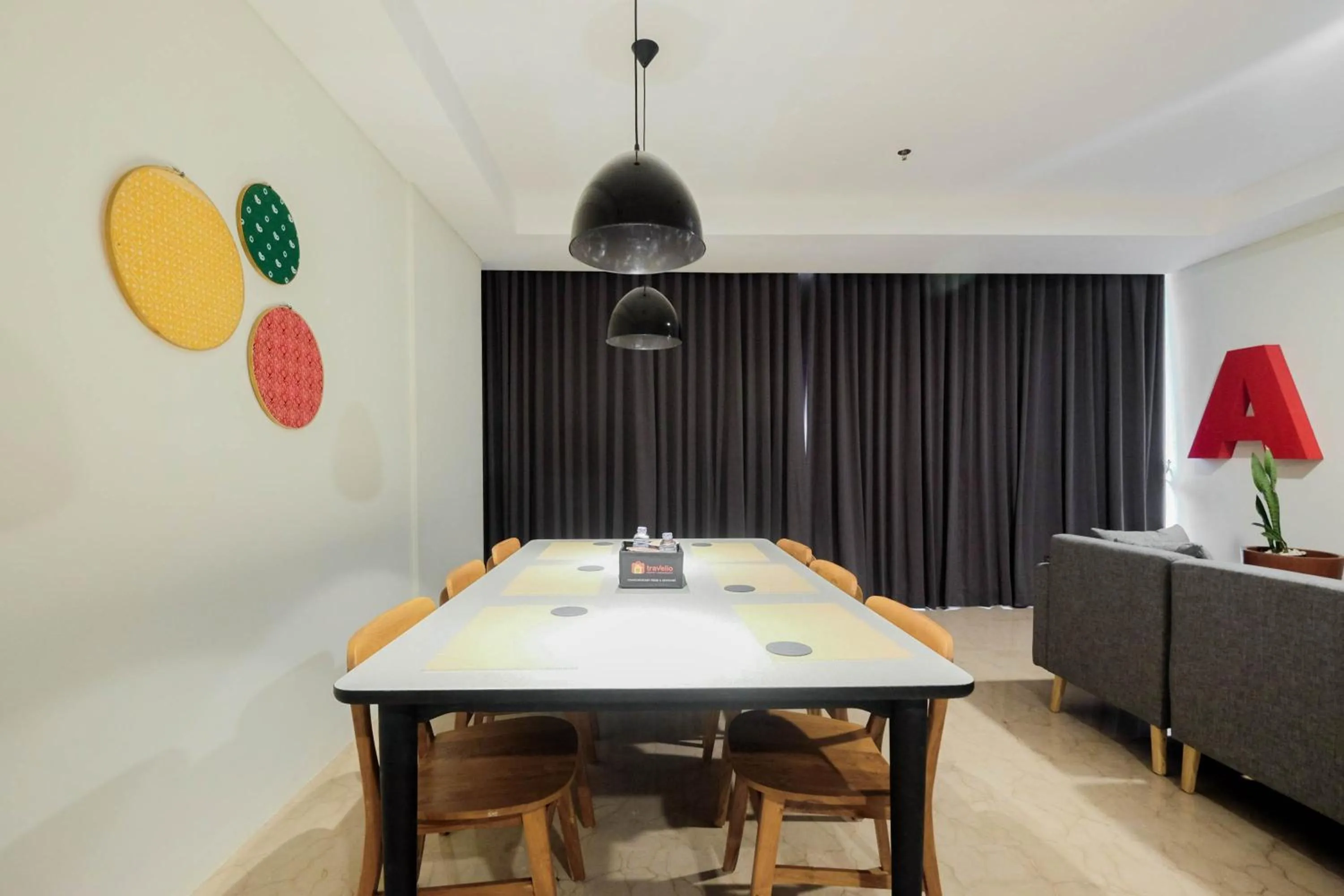 Dining area in Comfy 3BR at L'Avenue Apartment Pancoran By Travelio