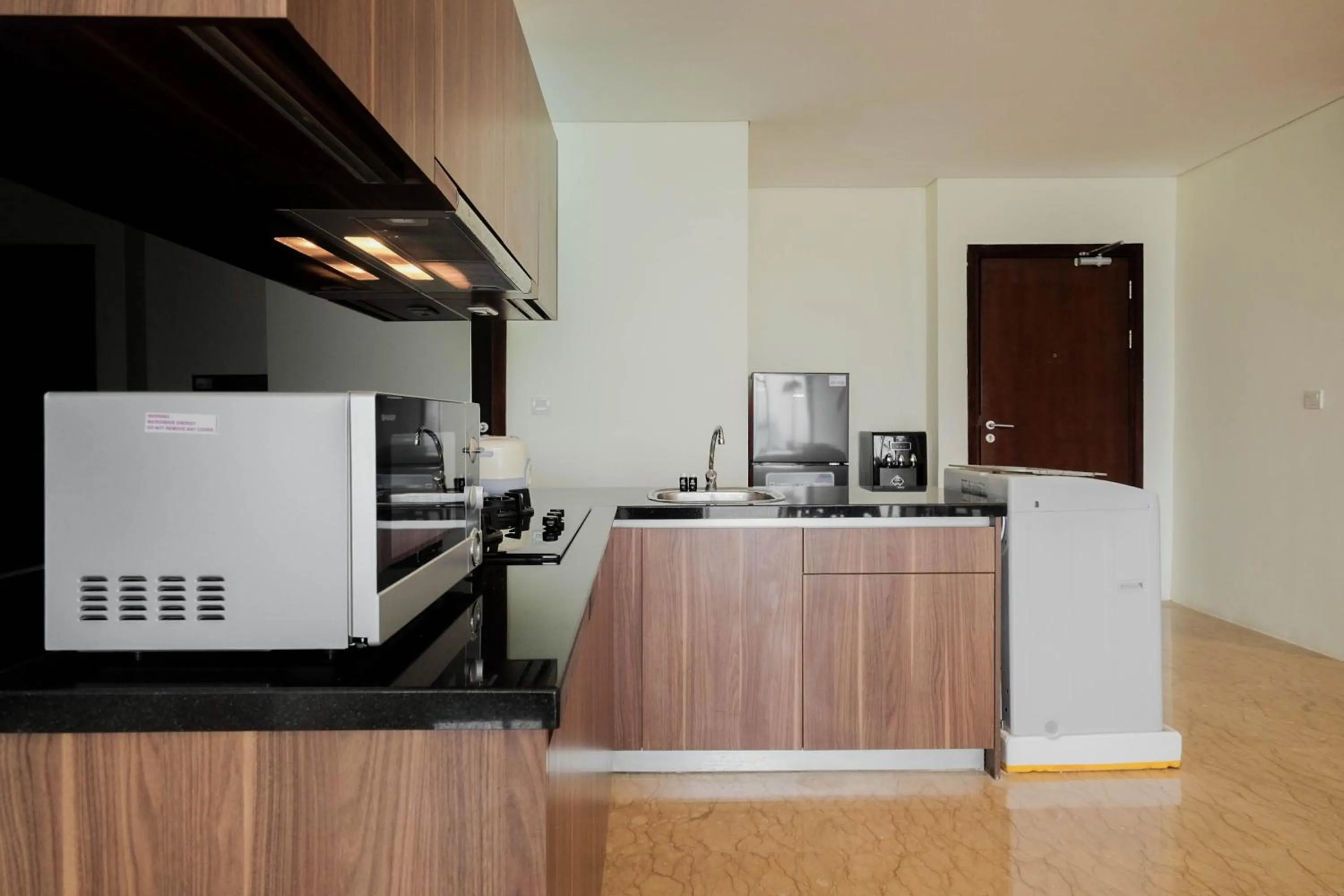 Kitchen or kitchenette in Comfy 3BR at L'Avenue Apartment Pancoran By Travelio