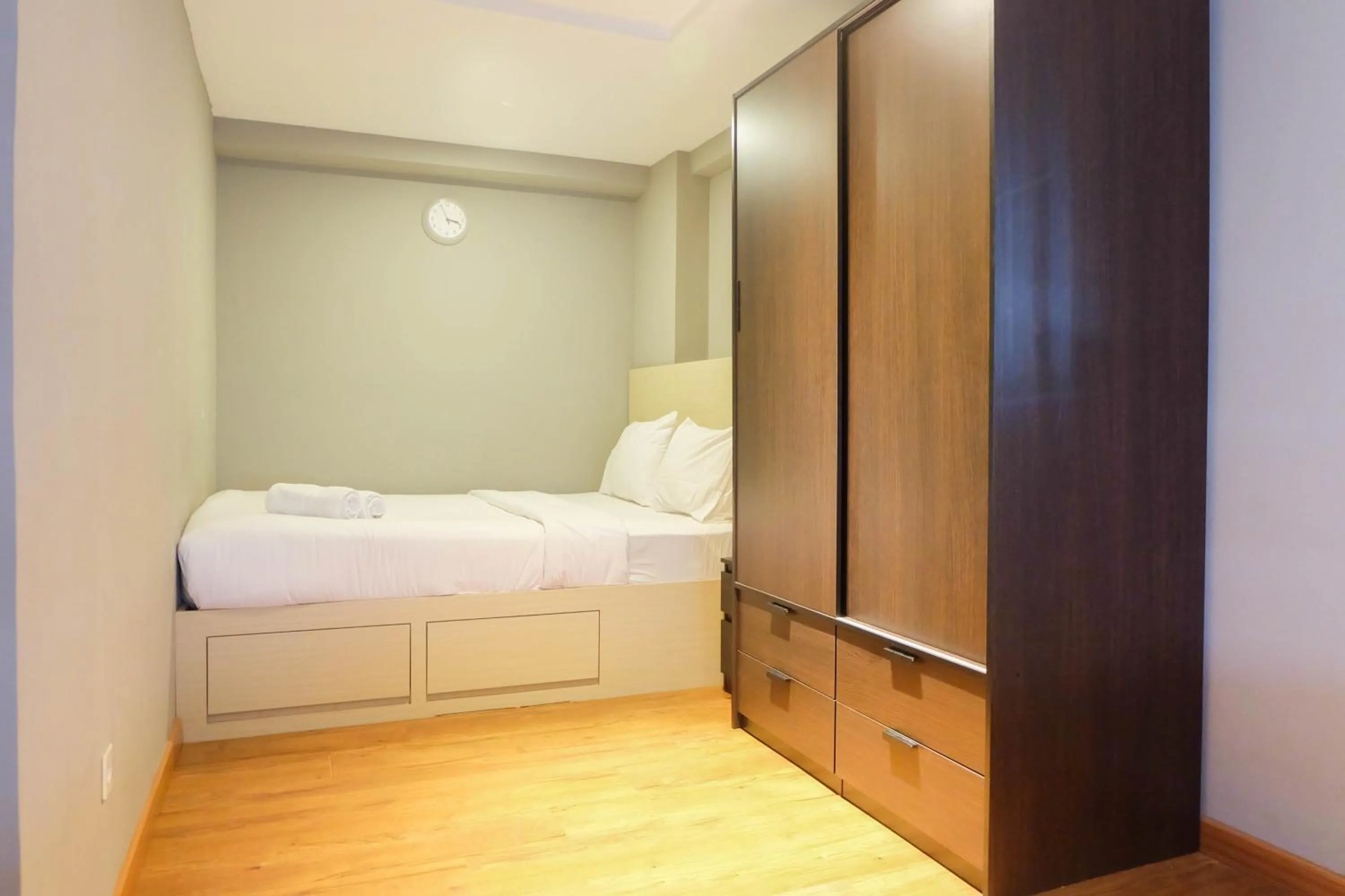 Bed in Exclusive and Spacious 1BR Apartment at Bassura City By Travelio