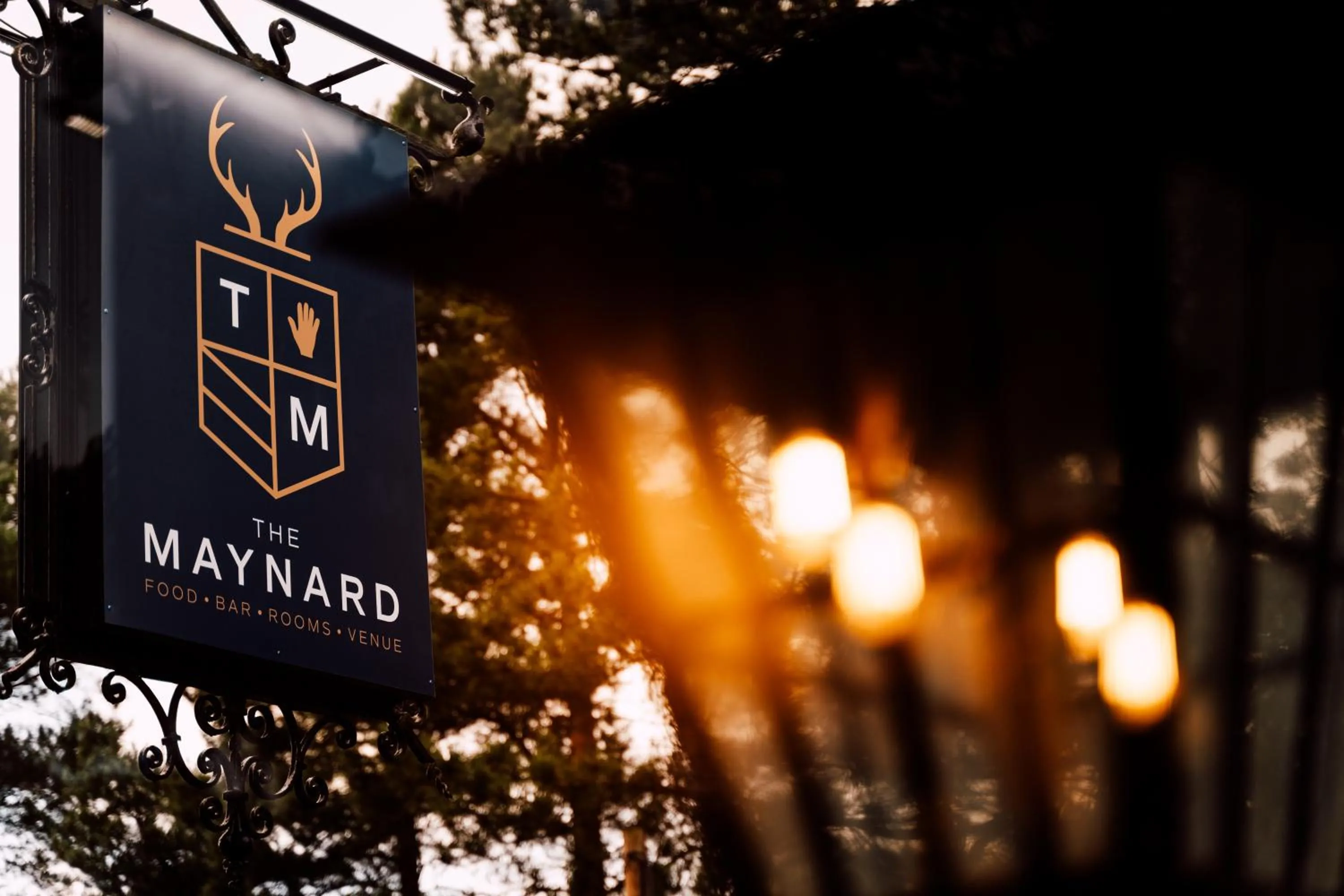 Property logo or sign in The Maynard