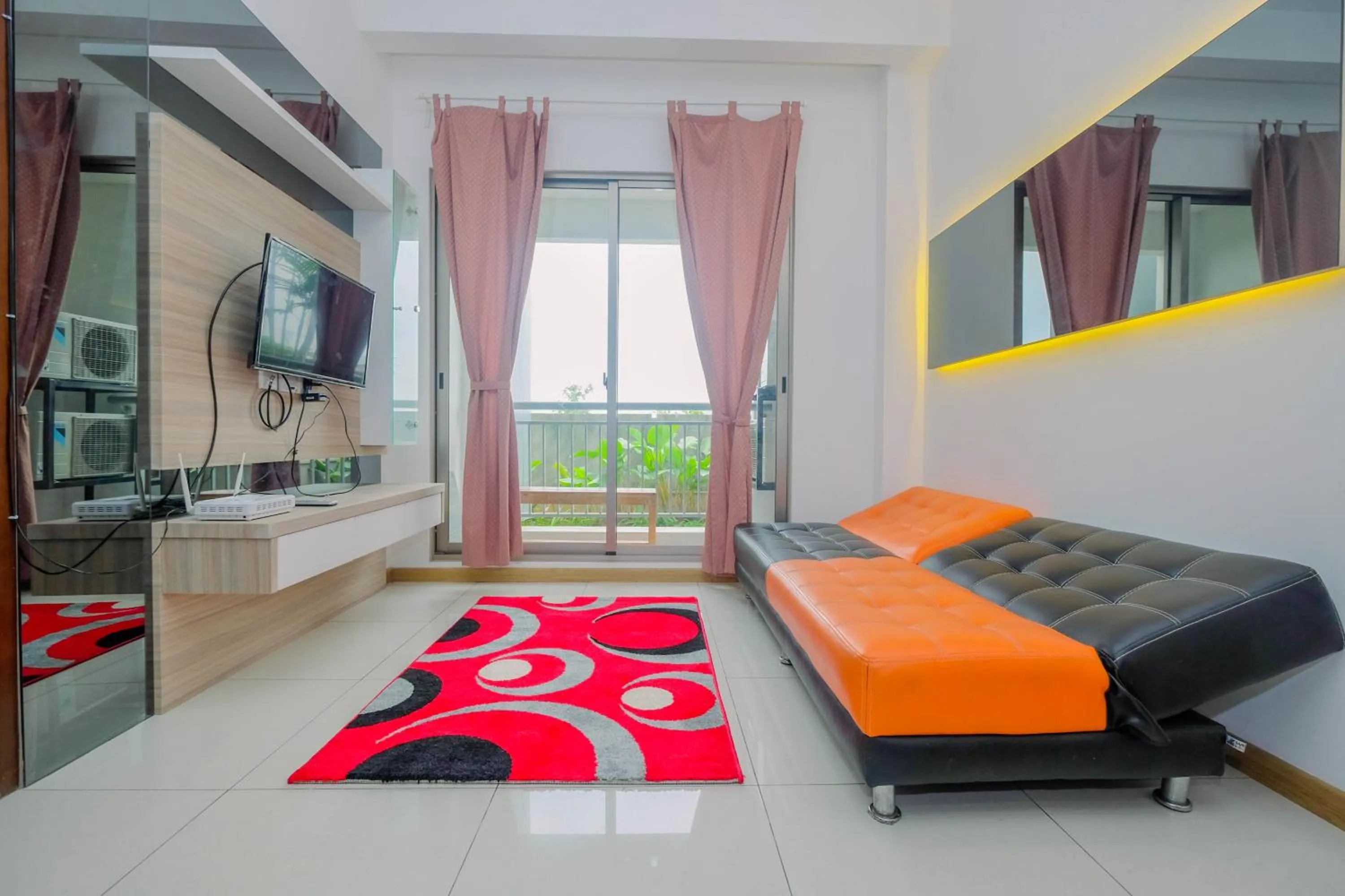Living room in Highest Value 1BR Apartment at M-Town Signature By Travelio