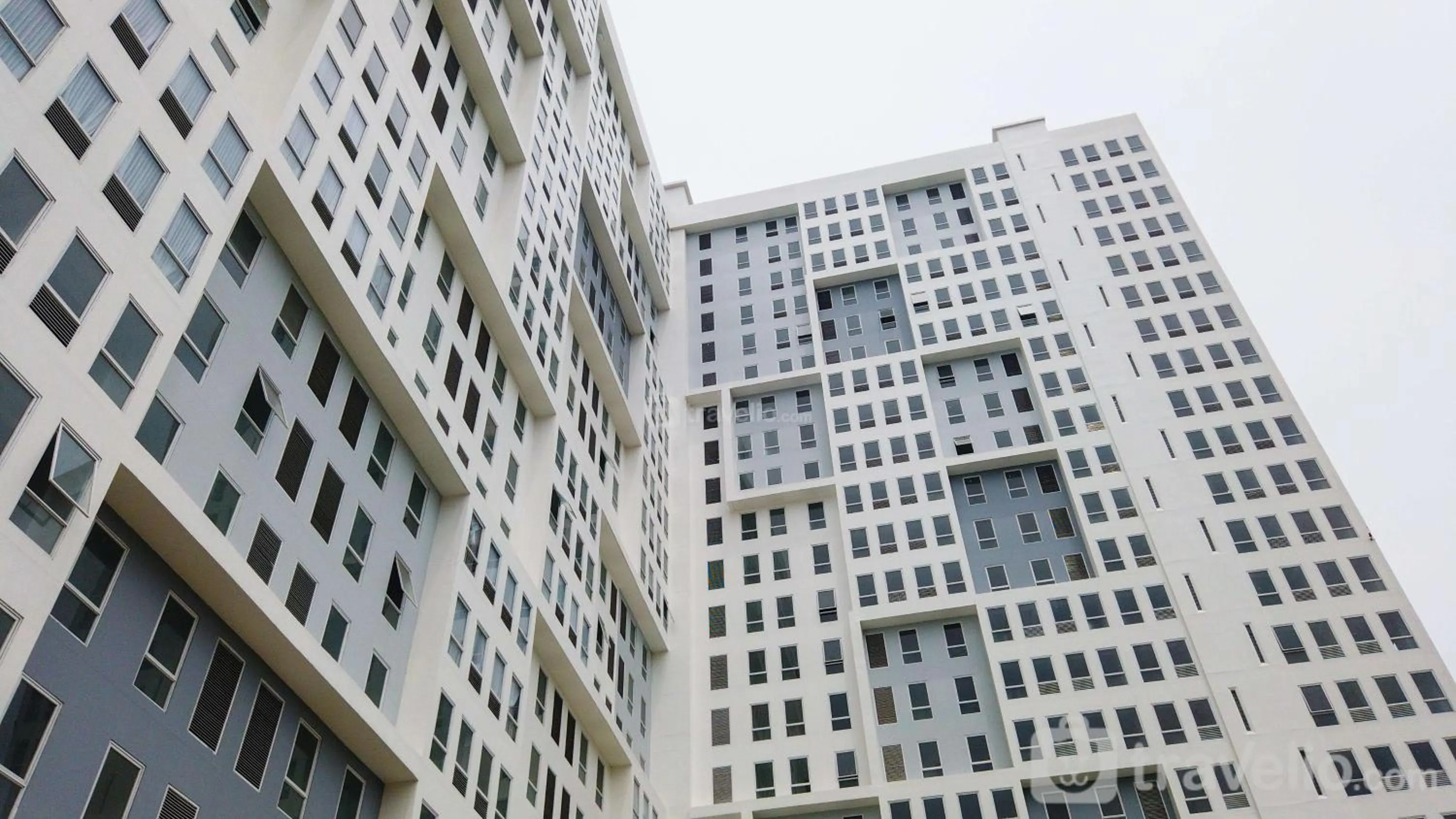 Property building in Comfy Studio Room at Patraland Urbano Apartment By Travelio