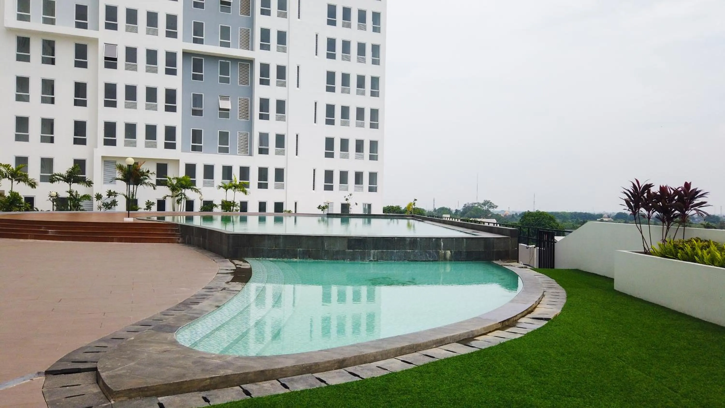 Property building in Comfy Studio Room at Patraland Urbano Apartment By Travelio