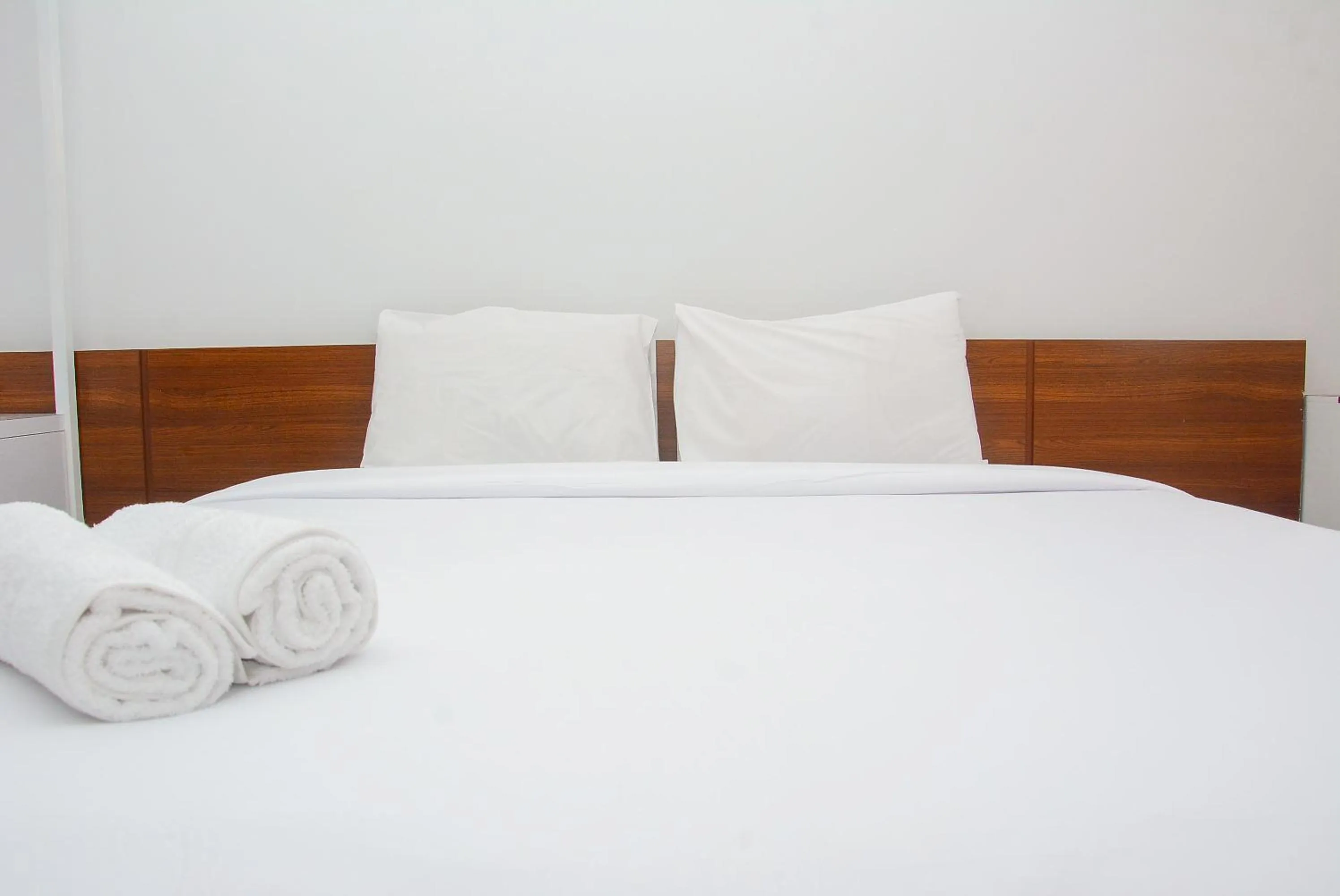 Bed in Comfy Studio Room at Patraland Urbano Apartment By Travelio