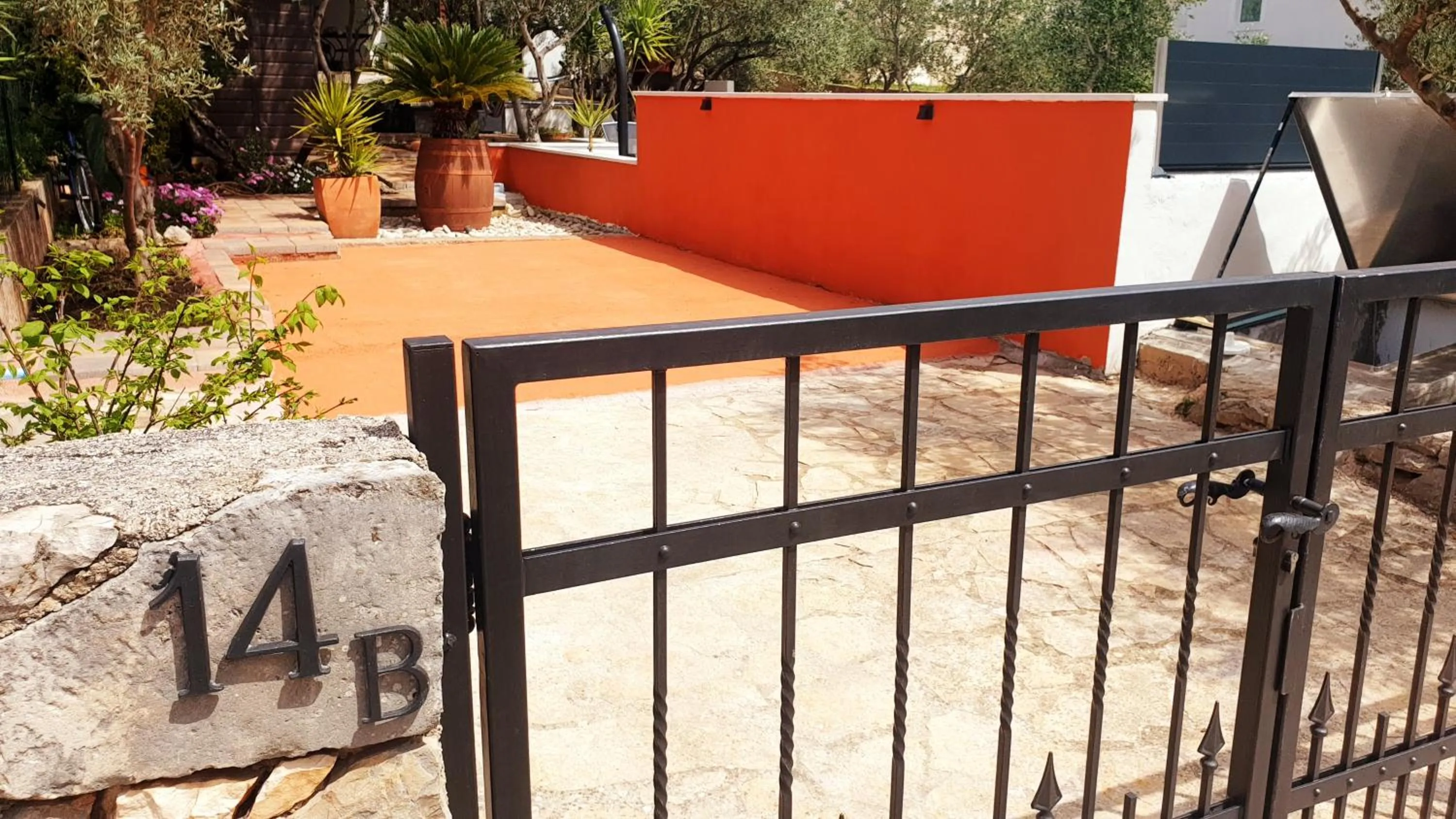 House with big walled oliva garden