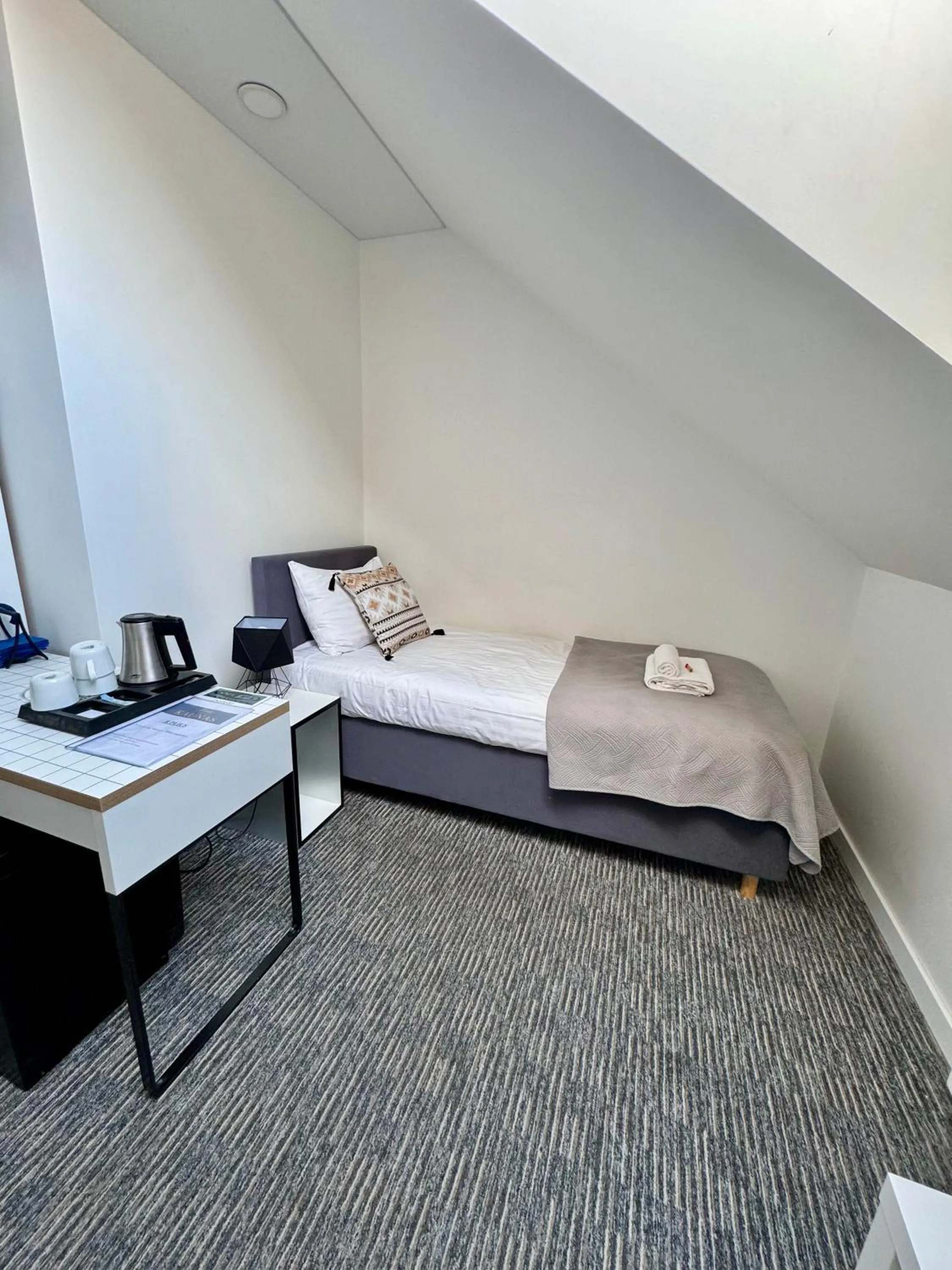 Bed in Grey apartments "Easy Kaunas"