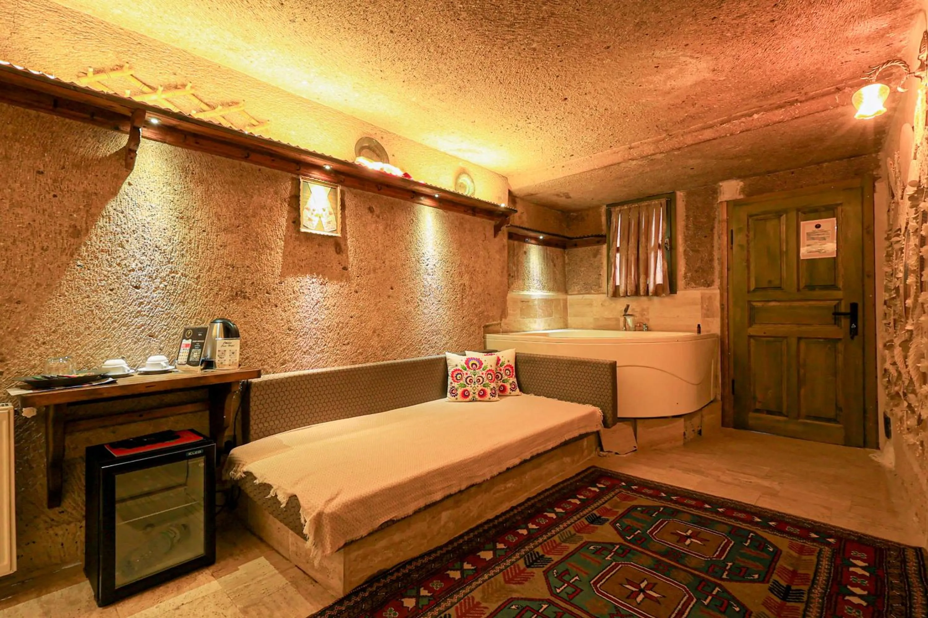 Seating area, Bed in Casia Cave Suites