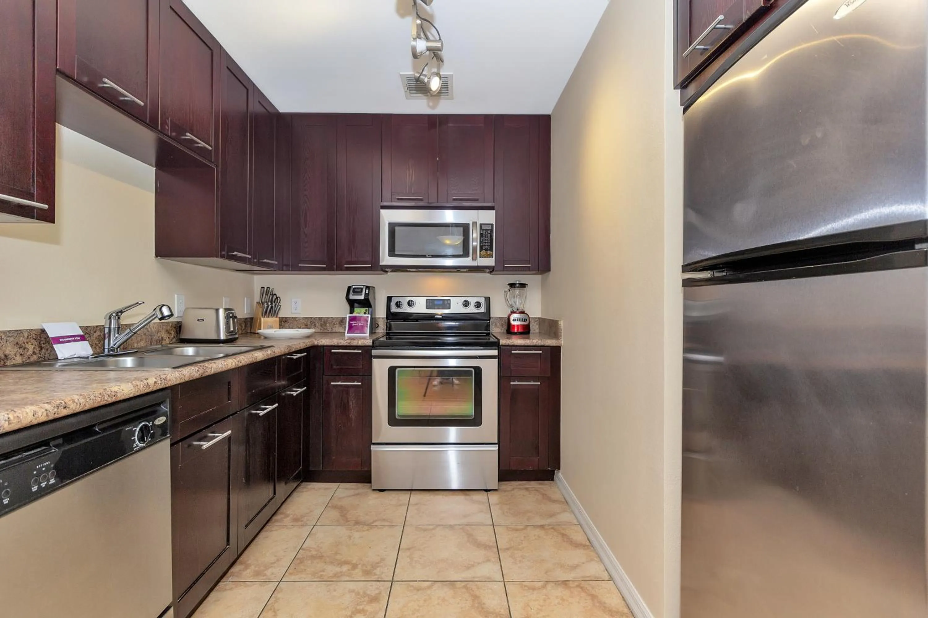 Kitchen or kitchenette in Dharma Home Suites South Miami at Red Road Commons