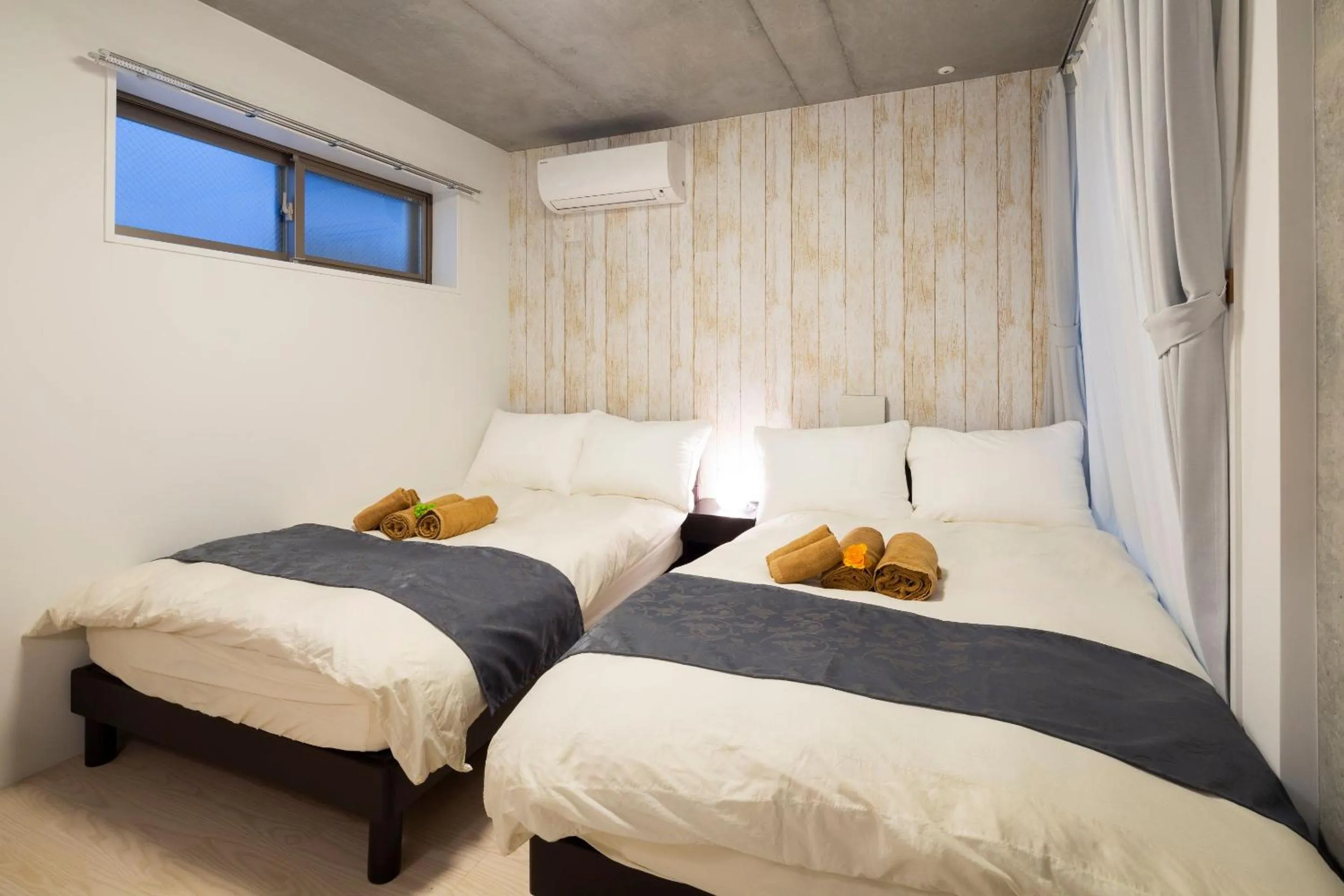 Bed in Laffitte Hirai Condominium Hotel