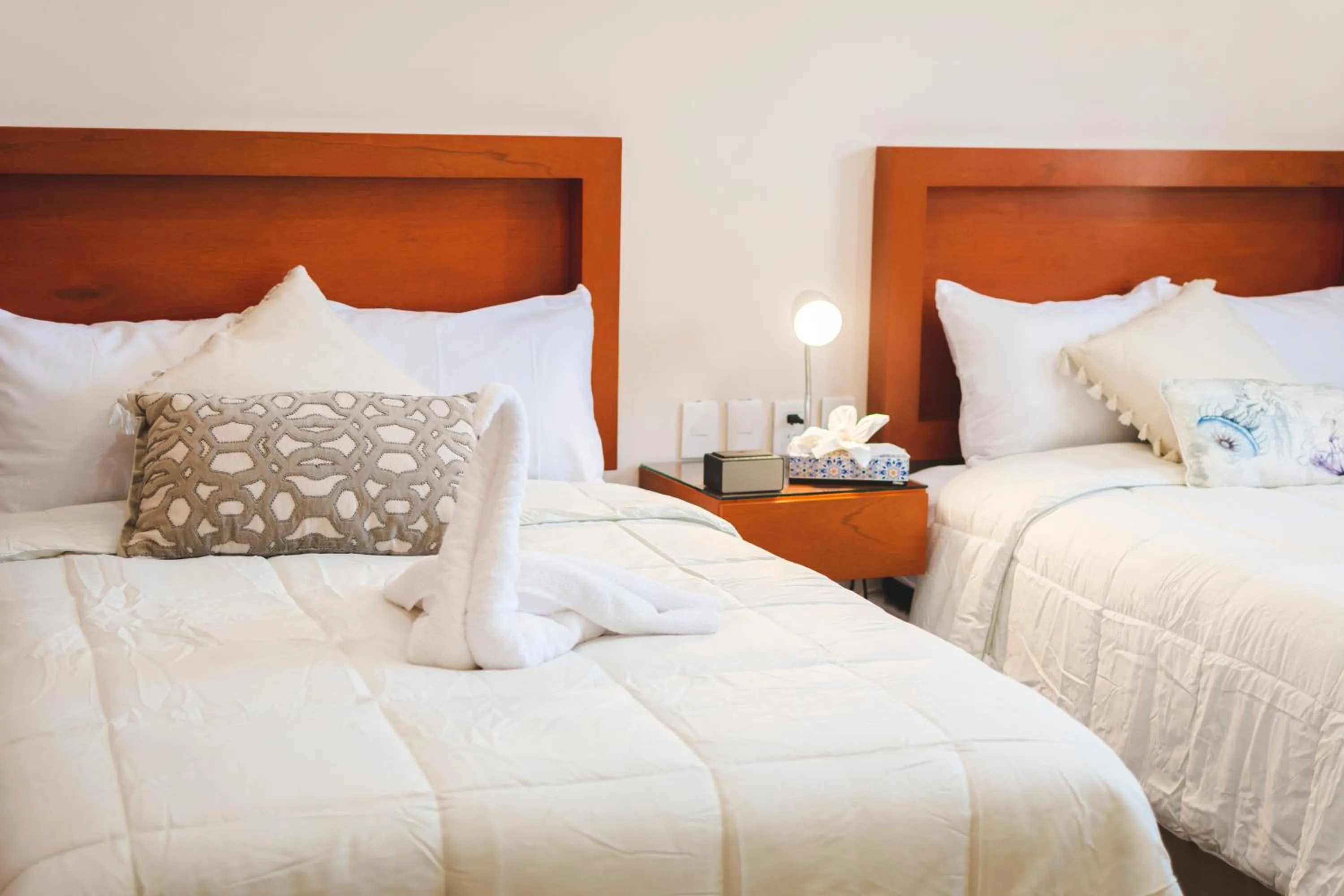 Bed in La Lola Hotel & Suites