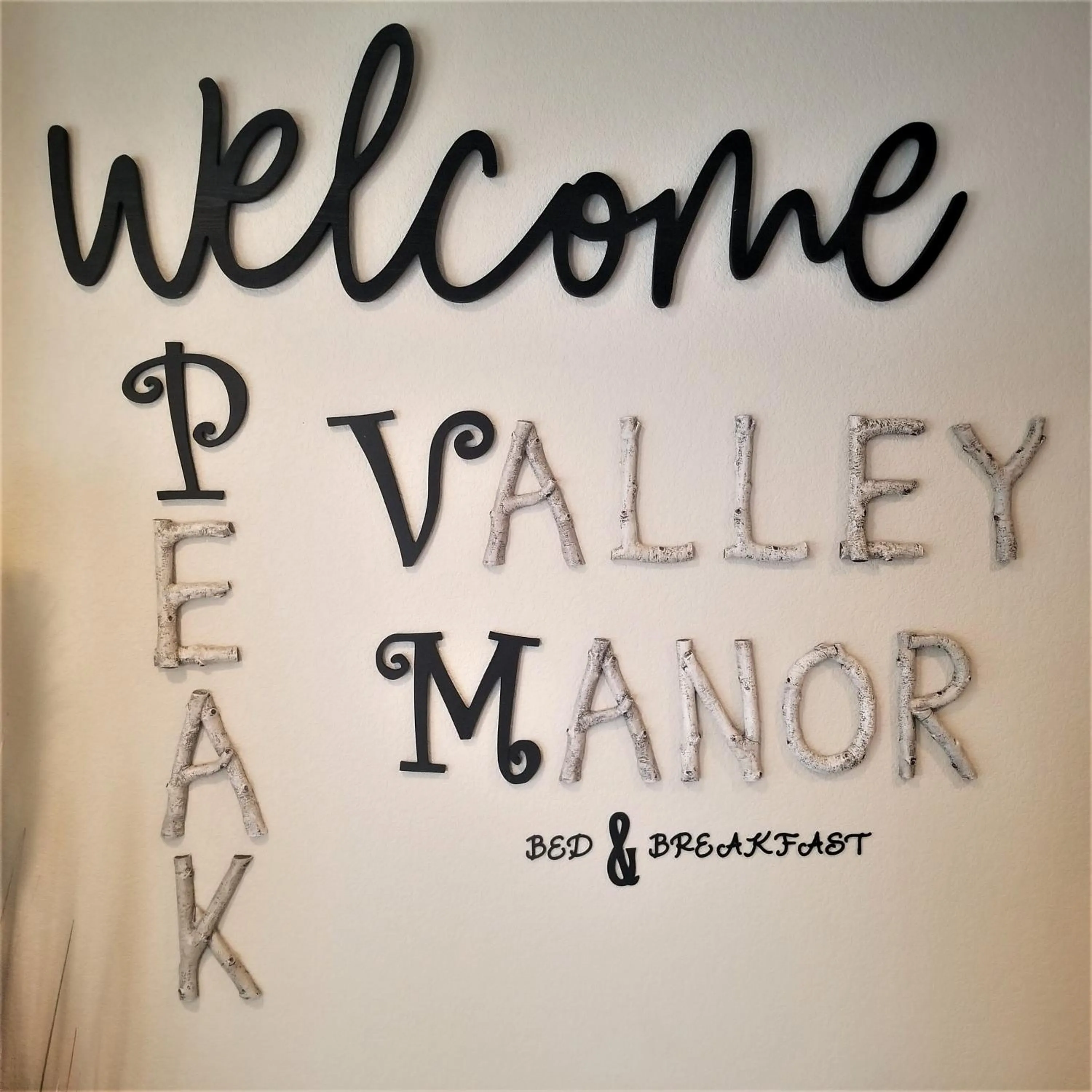 Property logo or sign in Peak Valley Manor, a Modern Farmhouse