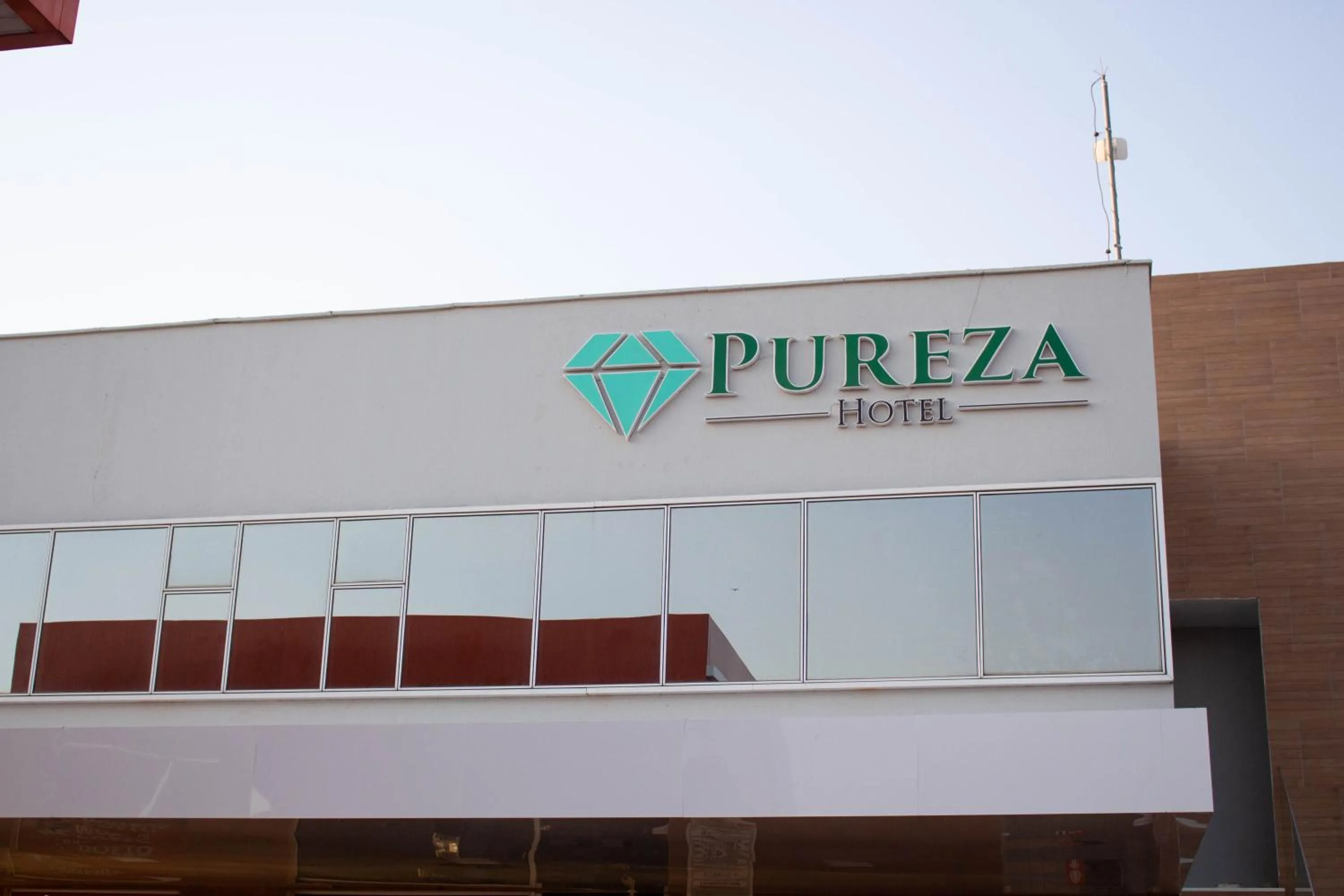 Property logo or sign in Pureza Hotel