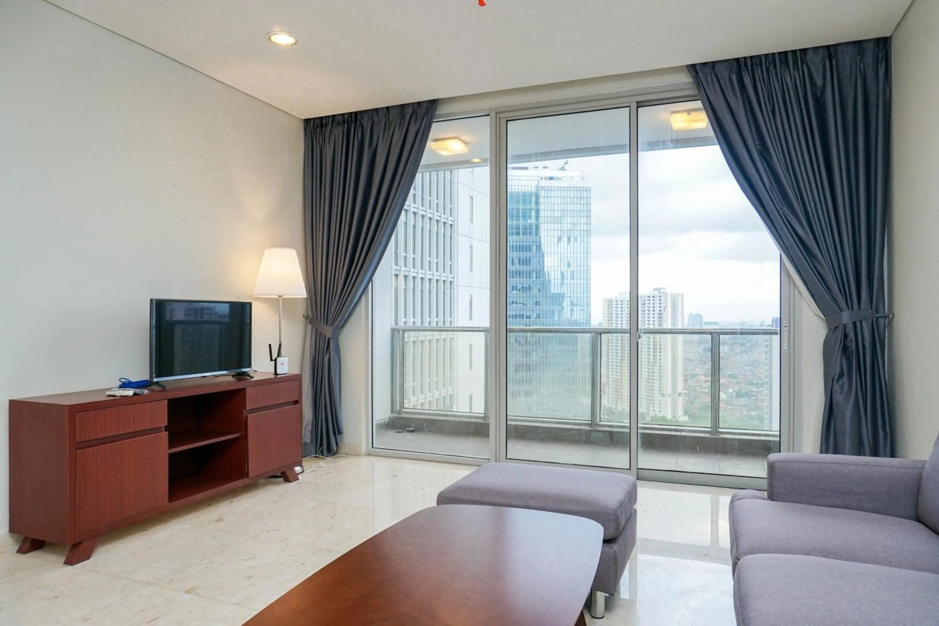 Cozy 2BR at Empyreal Epicentrum Apartment By Travelio