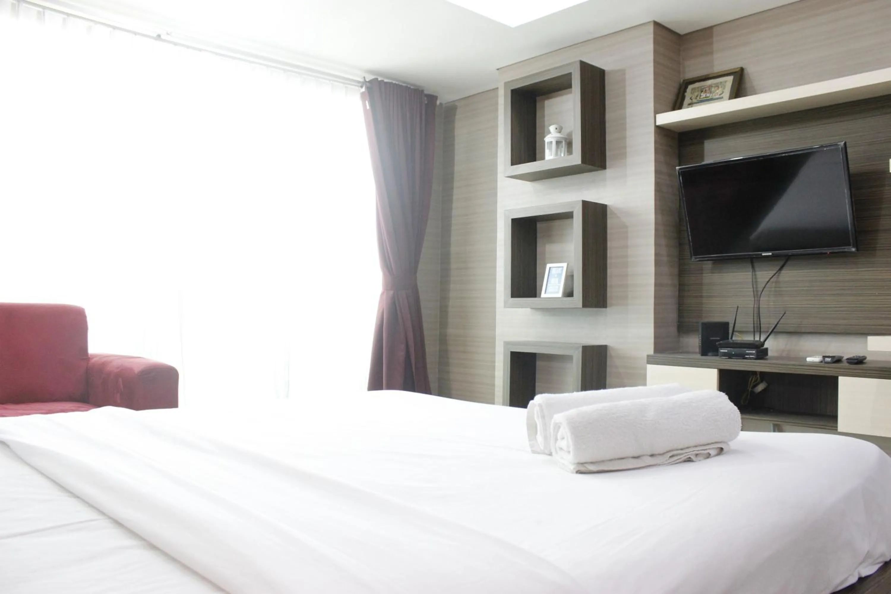 Photo of the whole room, Bed in Prime and Comfy Studio at Tamansari La Grande Apartment By Travelio